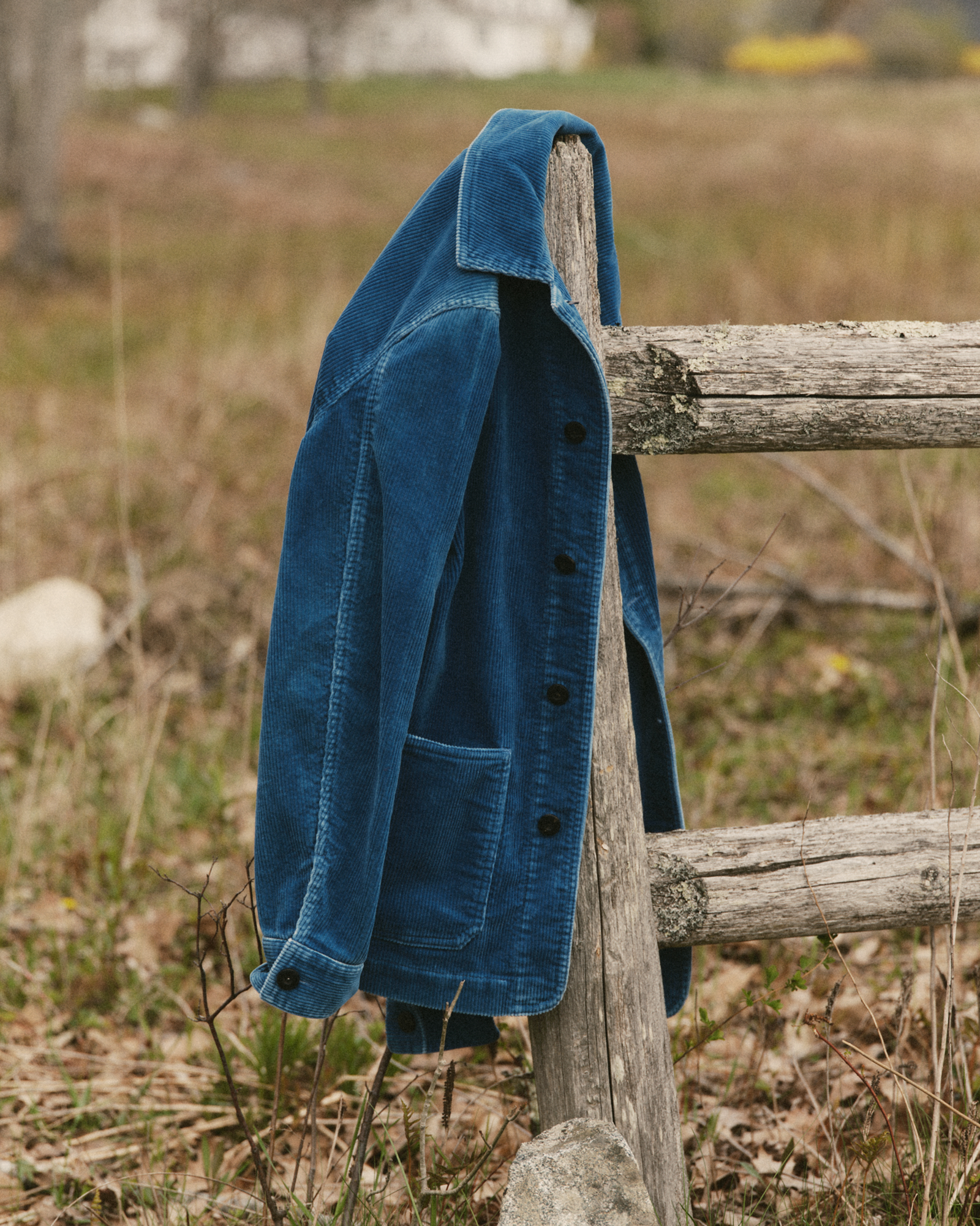 editorial image of The Ojai Jacket in Washed Indigo Corduroy hanging on a fence, Outerwear by Taylor Stitch