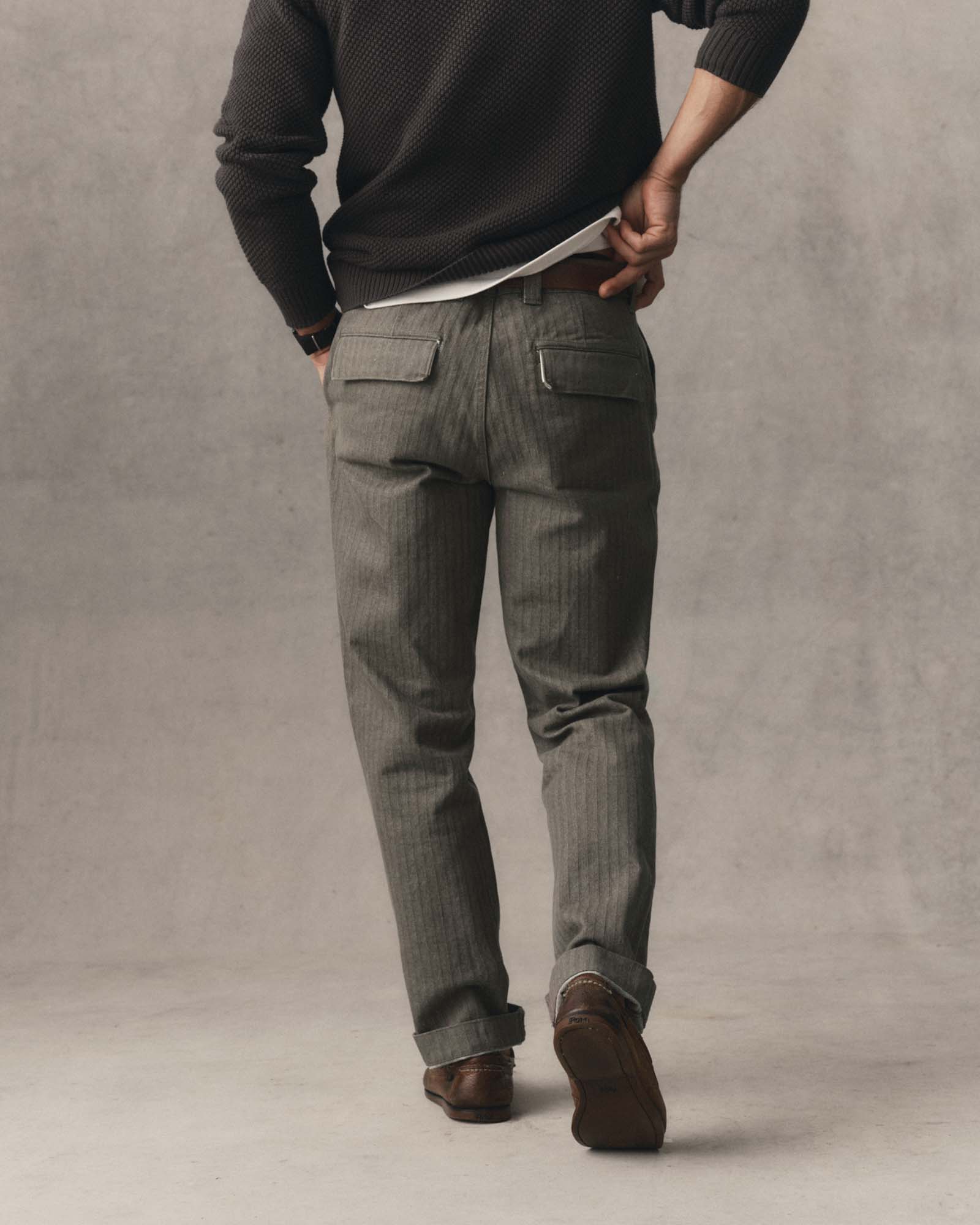 fit model walking wearing The Emlen Pant in Smoked Olive Herringbone, Bottoms by Taylor Stitch