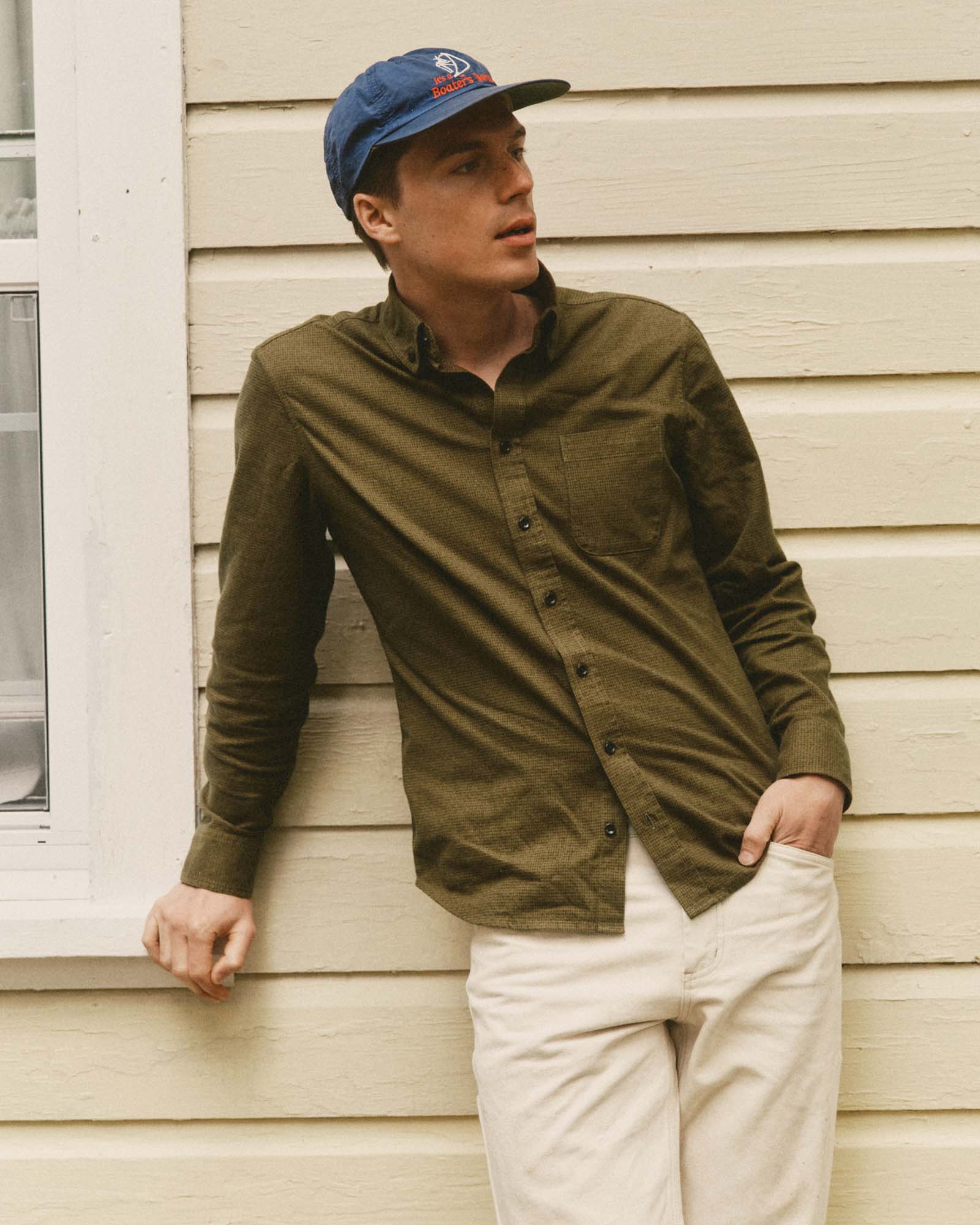 fit model leaning against the wall wearing The Jack in Bay Leaf Houndstooth, Wovens by Taylor Stitch