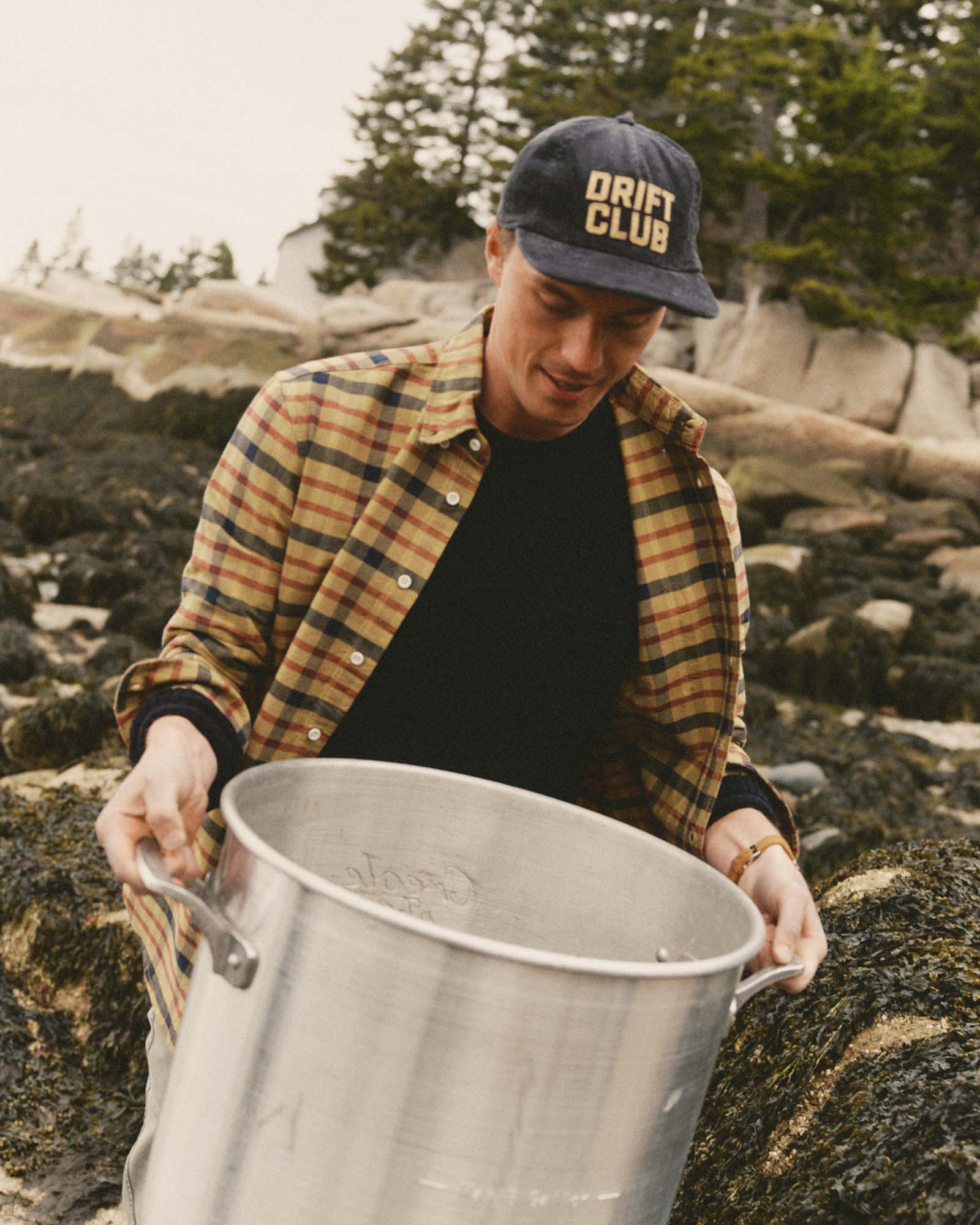 fit model holding a pot wearing The Jack in Marsh Check Oxford, Wovens by Taylor Stitch