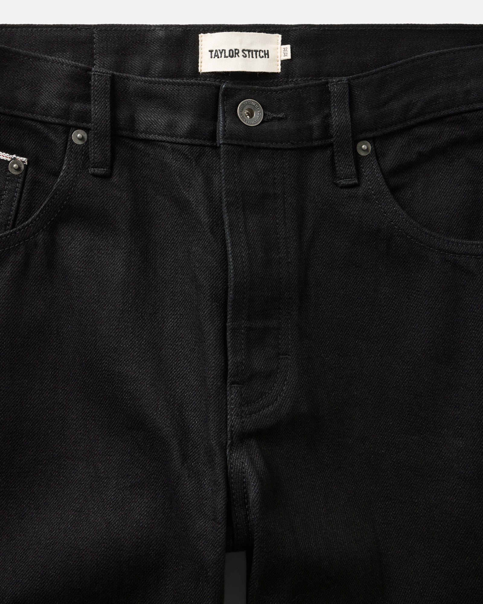 material shot of the waistband on The Straight Jean in Rinsed Black Organic Selvedge, Bottoms by Taylor Stitch