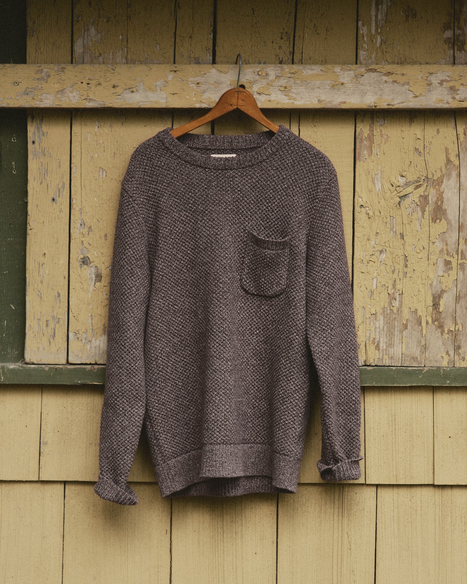 editorial image of The Crawford Crew Sweater in Burgundy Twist hanging, Sweaters by Taylor Stitch
