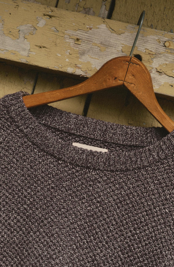 editorial image of The Crawford Crew Sweater in Burgundy Twist hanging