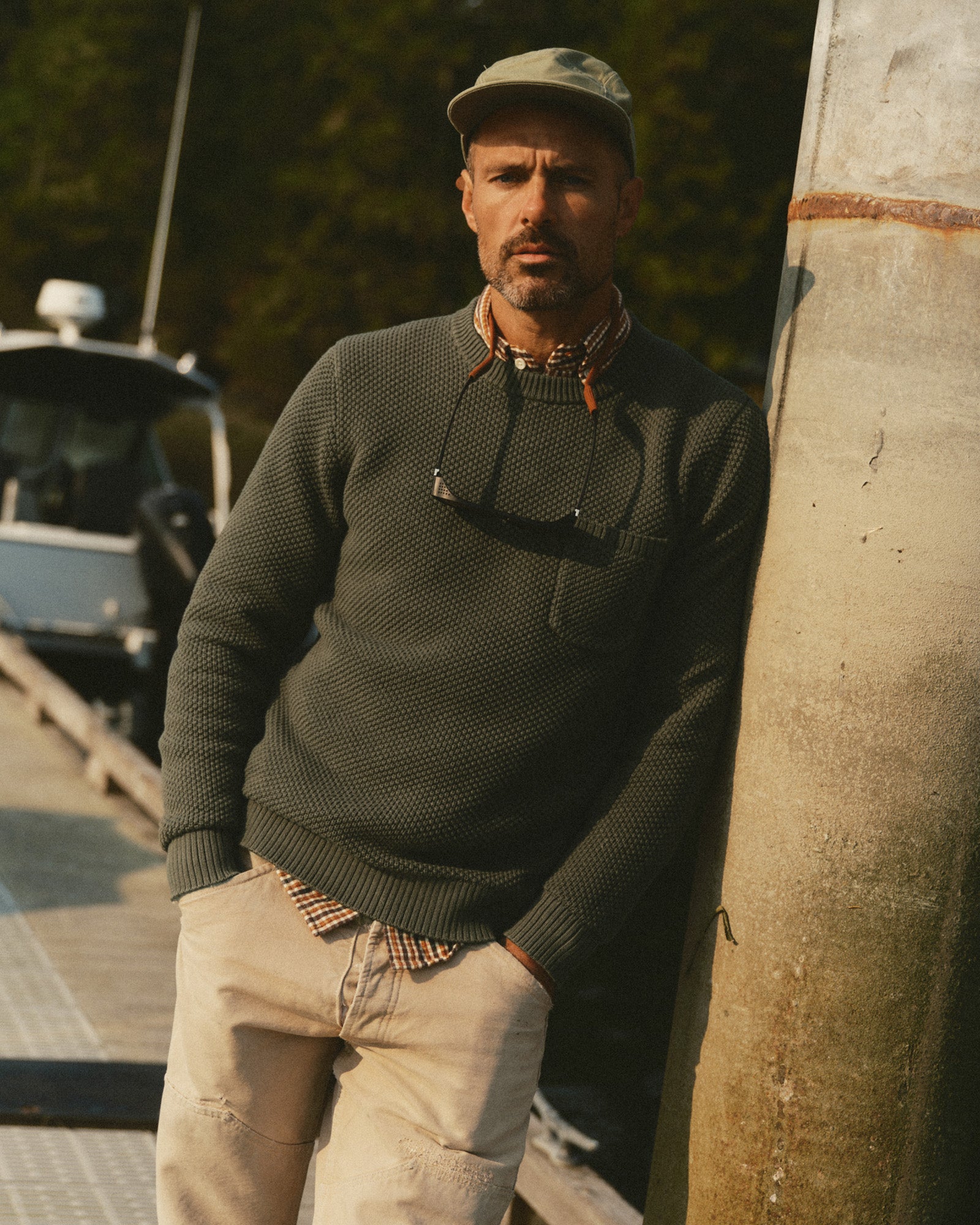 fit model leaning against the wall wearing The Crawford Crew Sweater in Fatigue Olive, Sweaters by Taylor Stitch