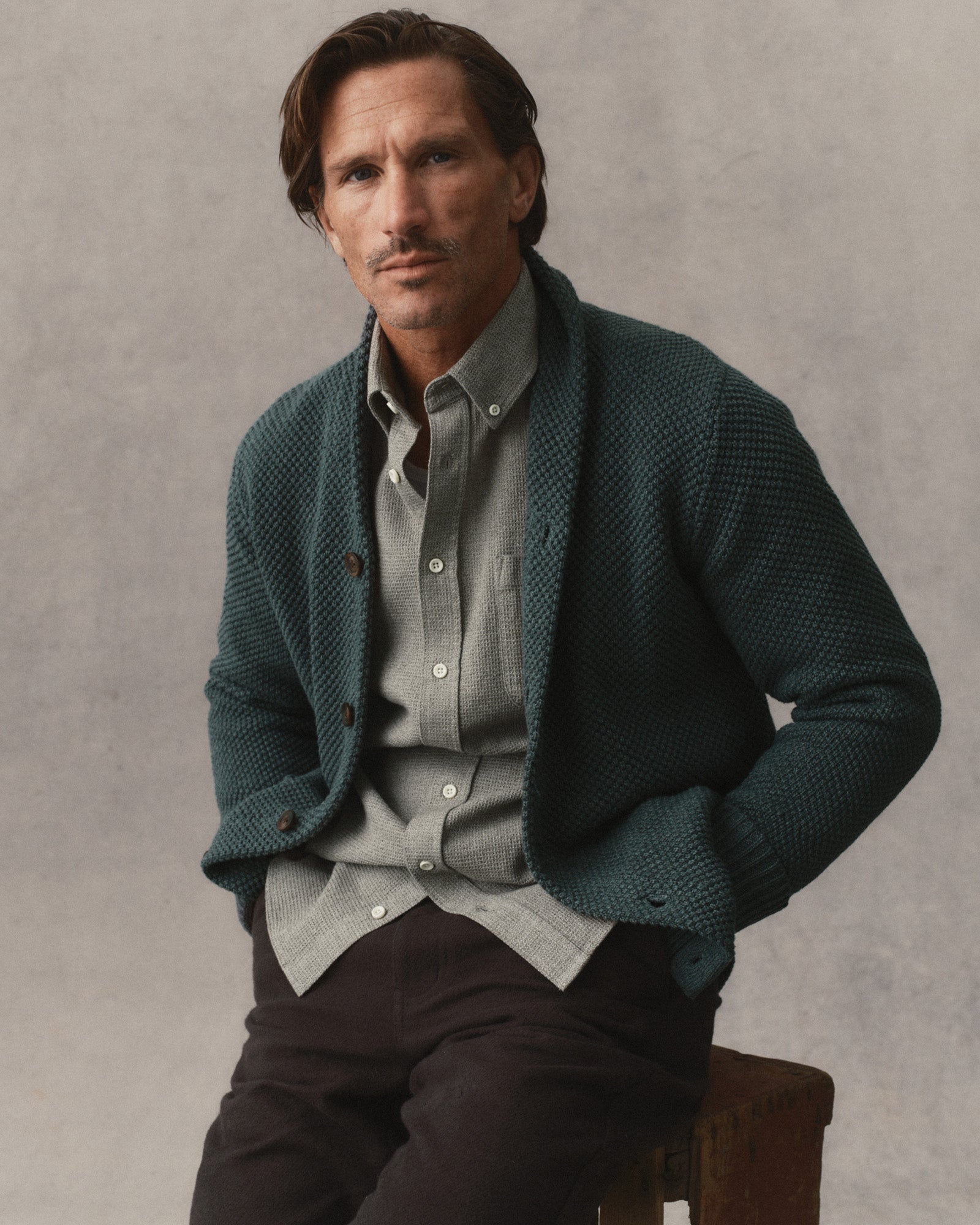 fit model sitting wearing The Crawford Sweater in Dark Forest Twist, Sweaters by Taylor Stitch