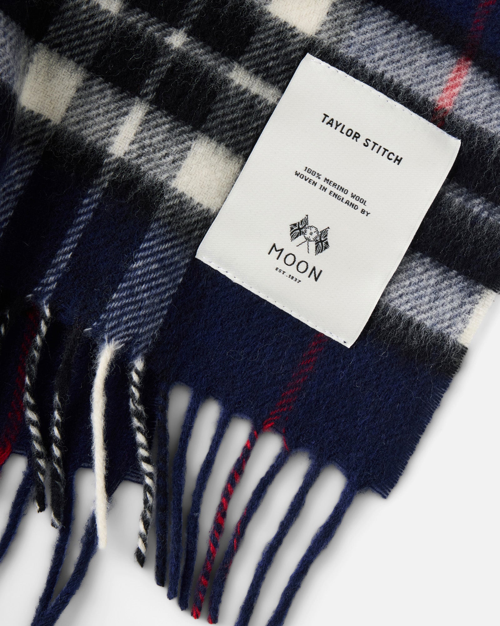 material shot of the label on The Fireside Scarf in Eddy Plaid, Accessories by Taylor Stitch