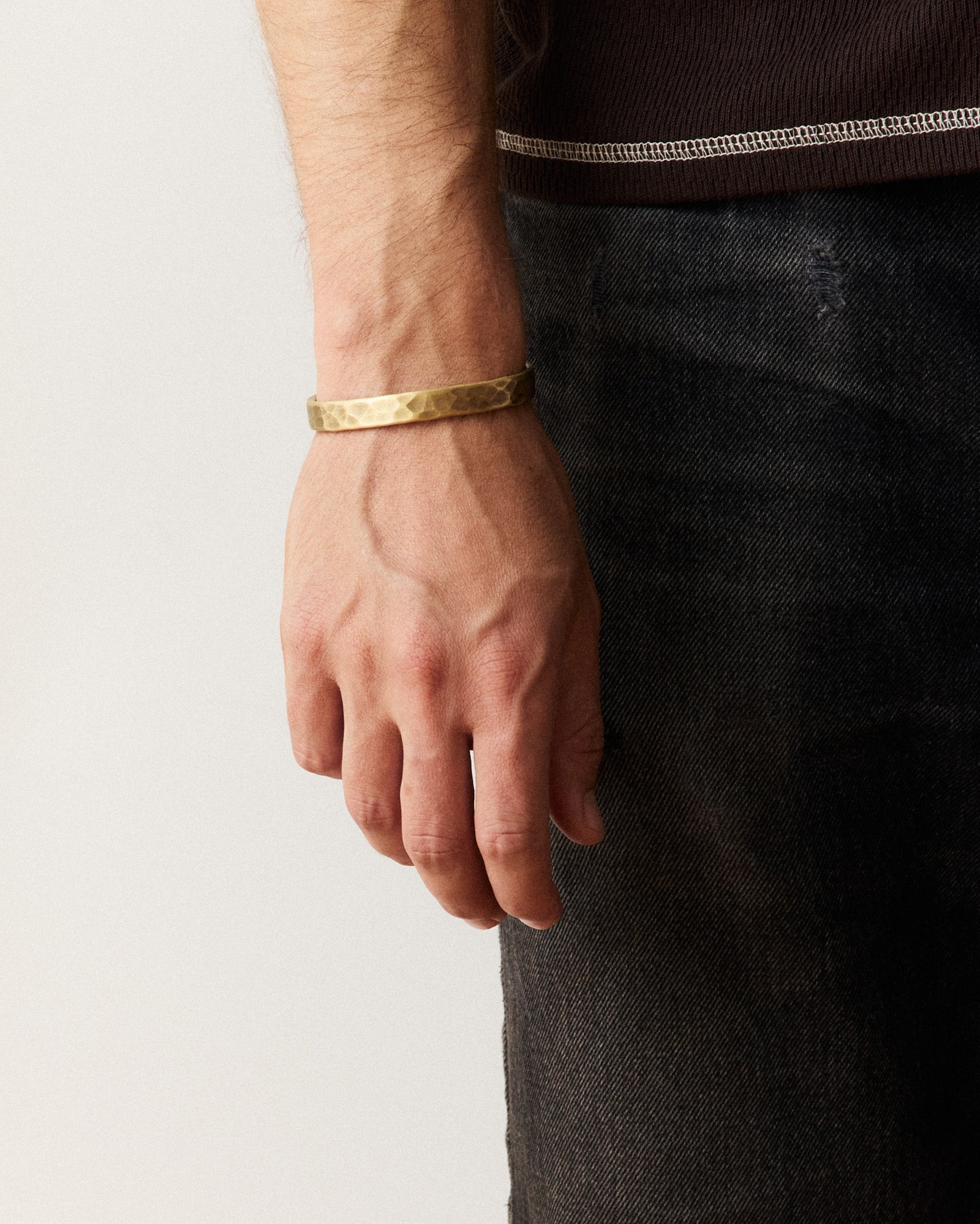 fit model posing in The Hammered Cuff in Brass, Accessories by Taylor Stitch