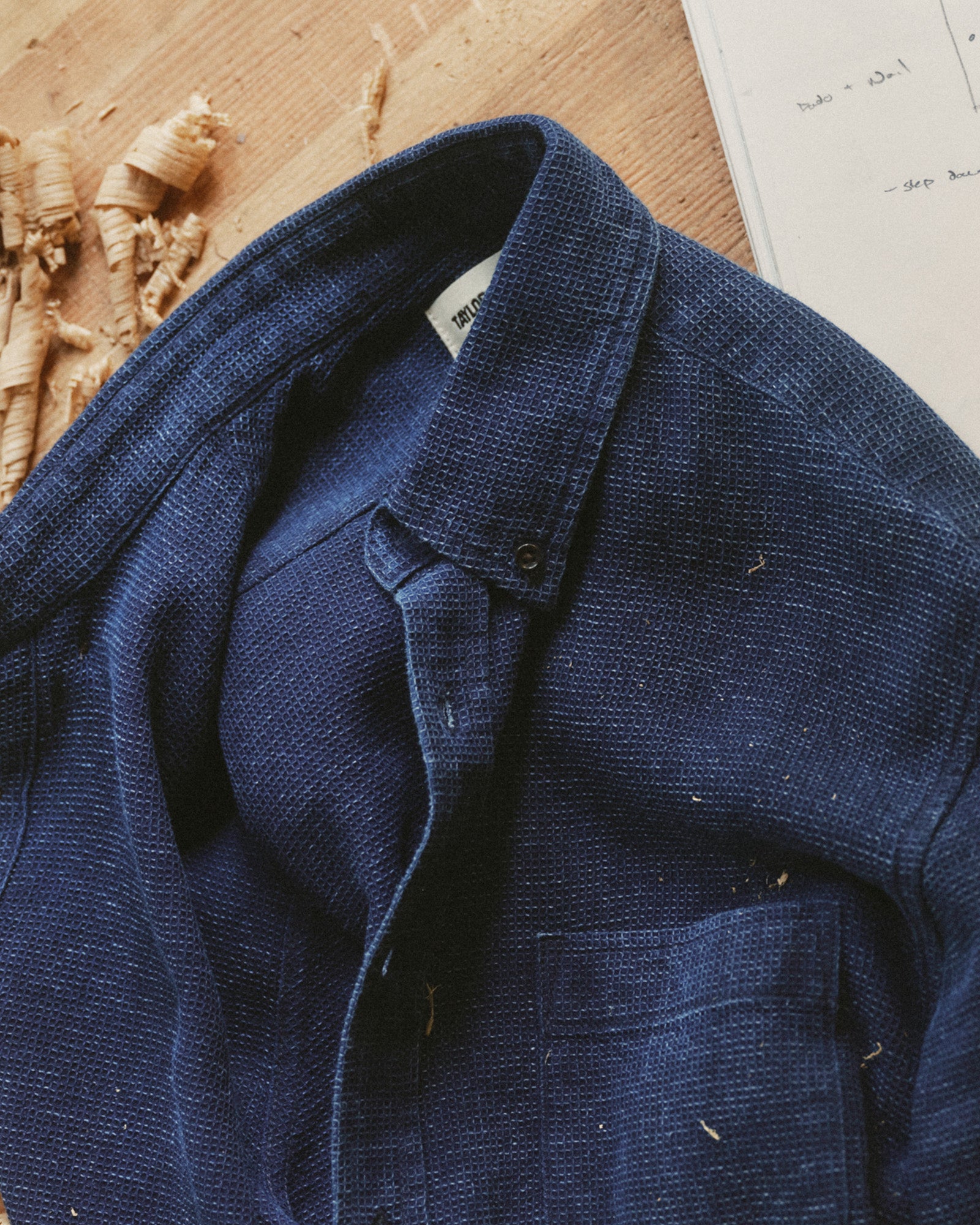 Close up of The Jack in Rinsed Indigo Waffle on a work table, Wovens by Taylor Stitch
