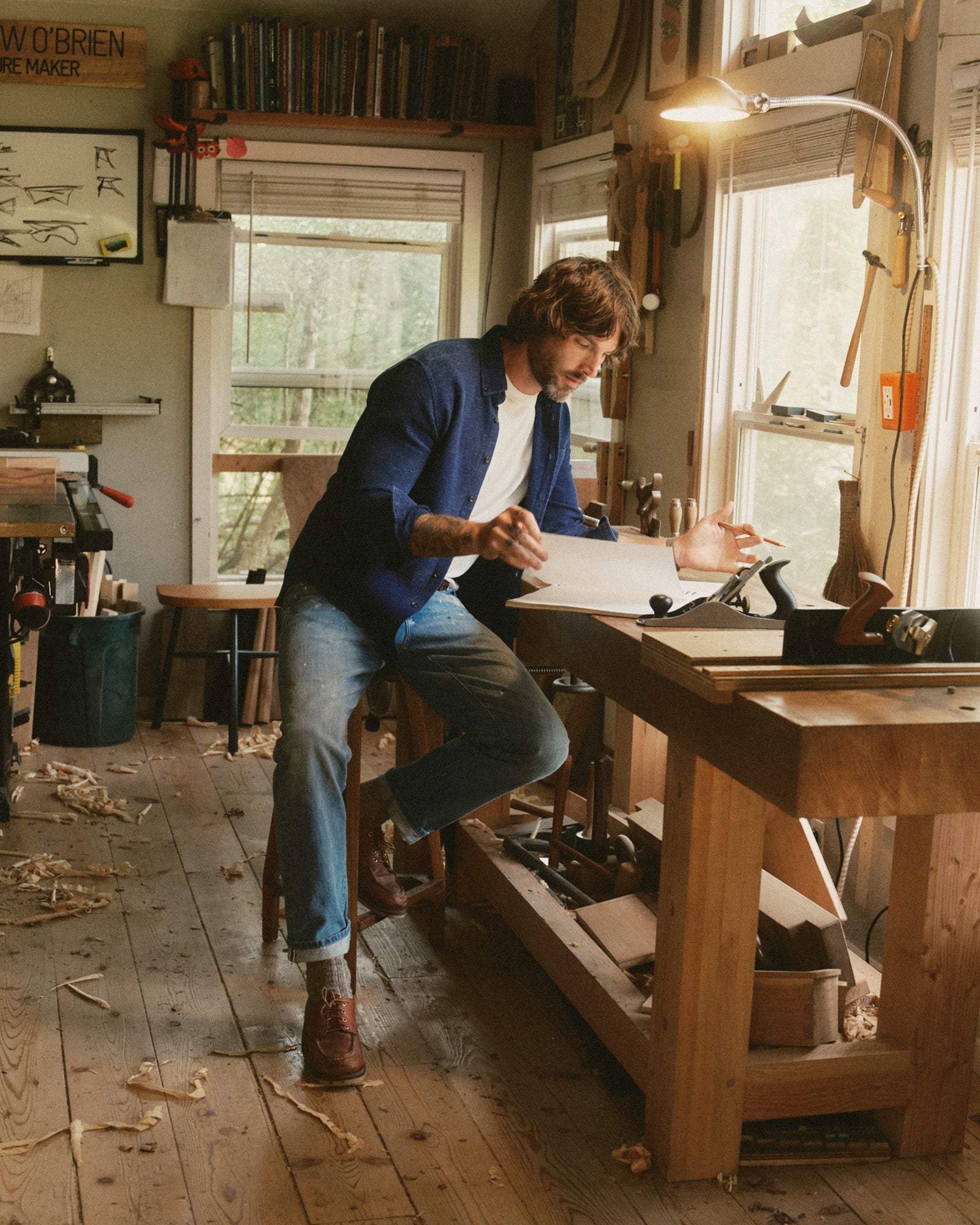 fit model sitting by a work bench, in The Jack in Rinsed Indigo Waffle, Wovens by Taylor Stitch