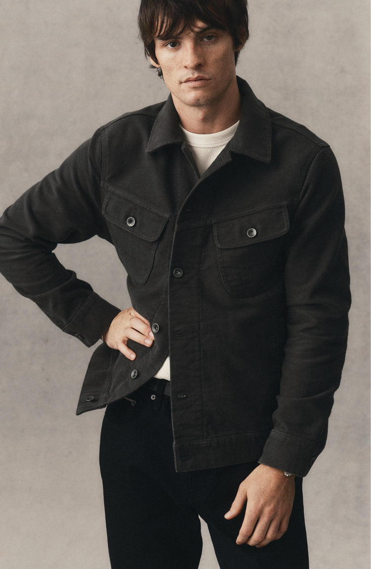 fit model posing in The Long Haul Jacket in Faded Black Washed Moleskin