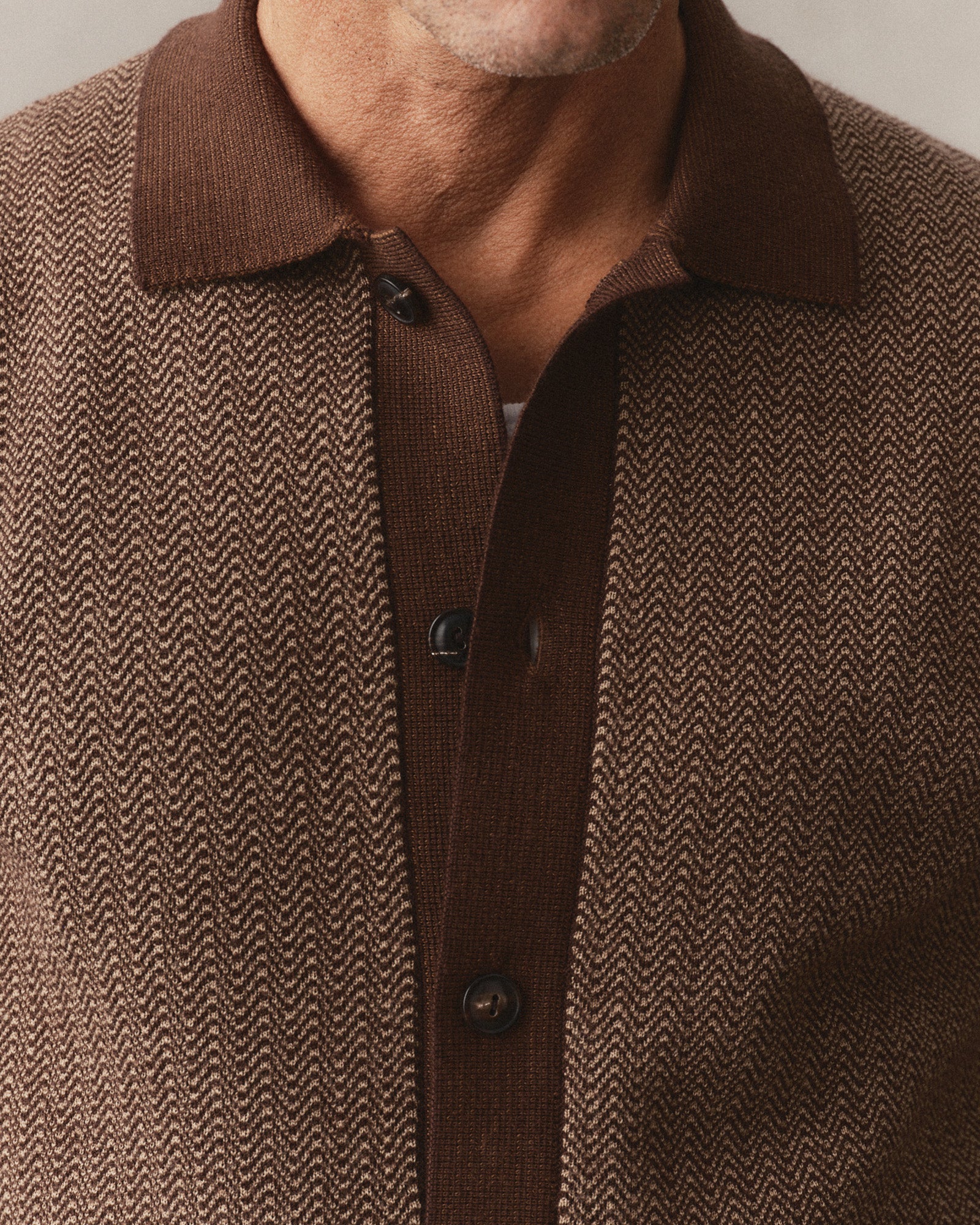 fit model showing off the buttons on The Miles Sweater Polo in Espresso Merino, Sweaters by Taylor Stitch
