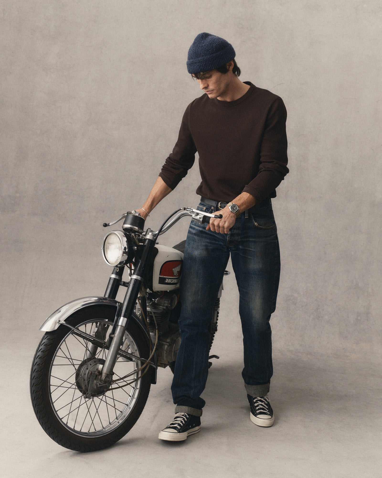 fit model with a motorcycle wearing The Organic Cotton Crew in Soil Waffle, Knits by Taylor Stitch