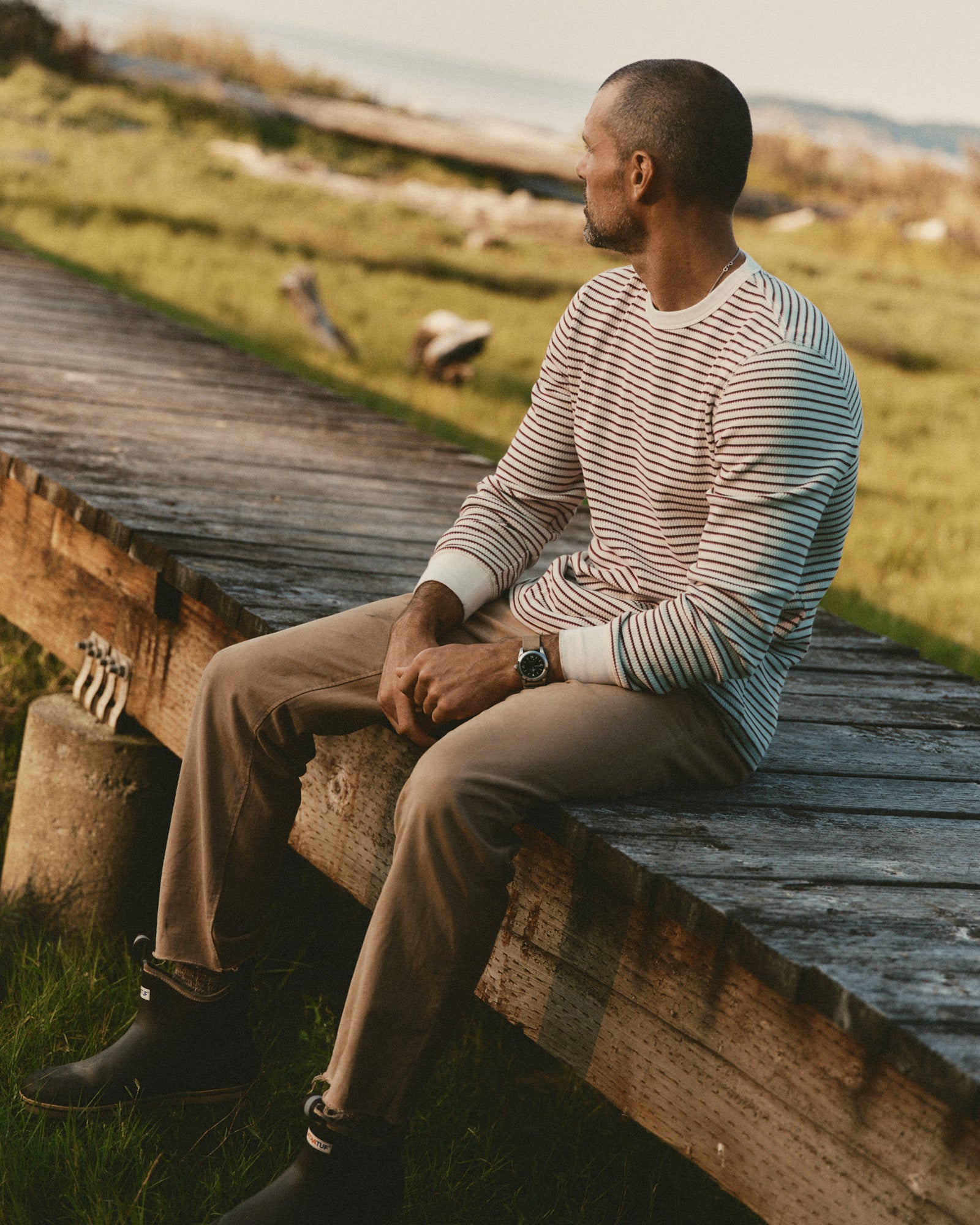 fit model sitting wearing The Organic Cotton Crew in Vintage White Stripe Waffle, Knits by Taylor Stitch