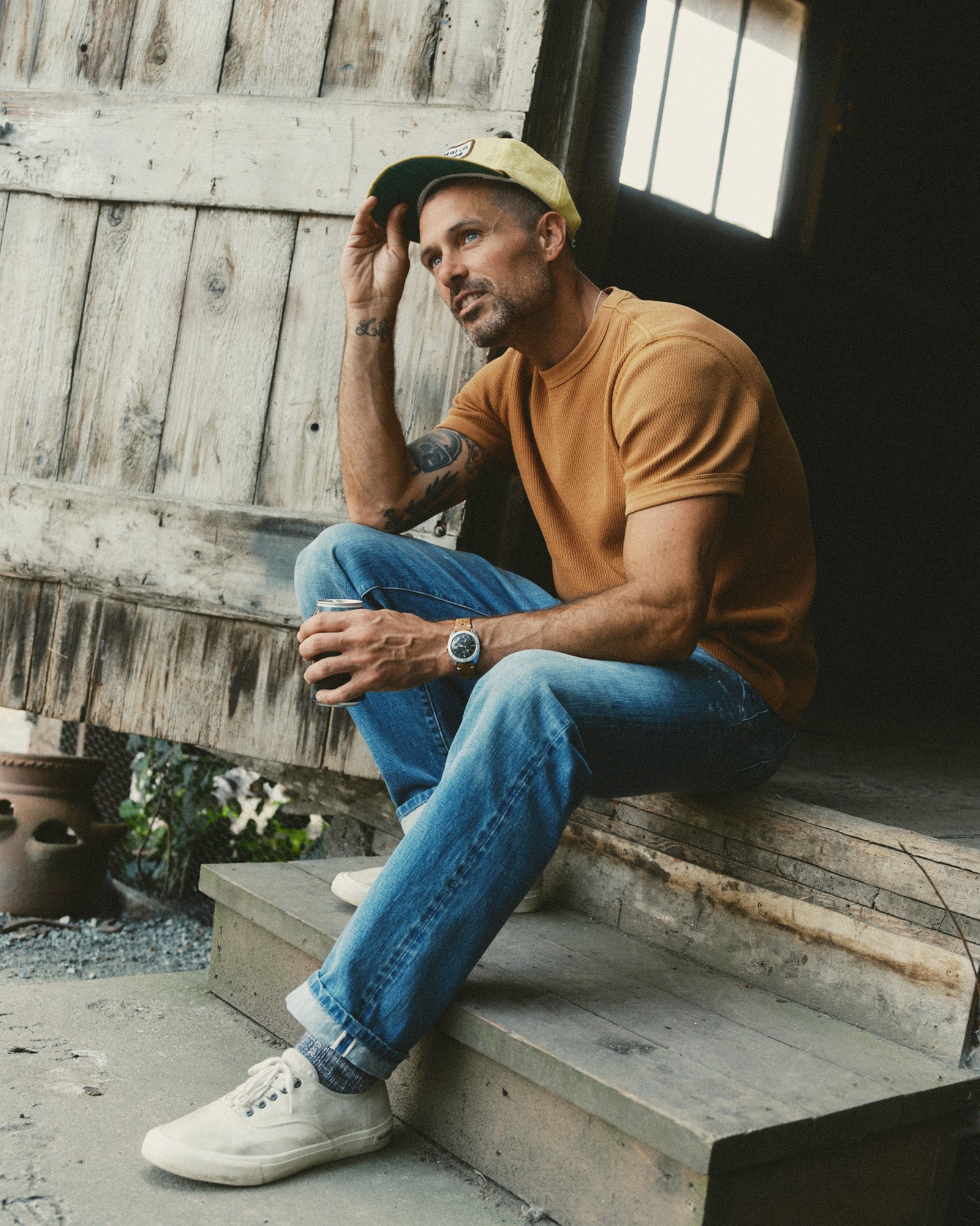 fit model sitting wearing The Organic Cotton Short Sleeve Crew in Saffron Waffle, Knits by Taylor Stitch