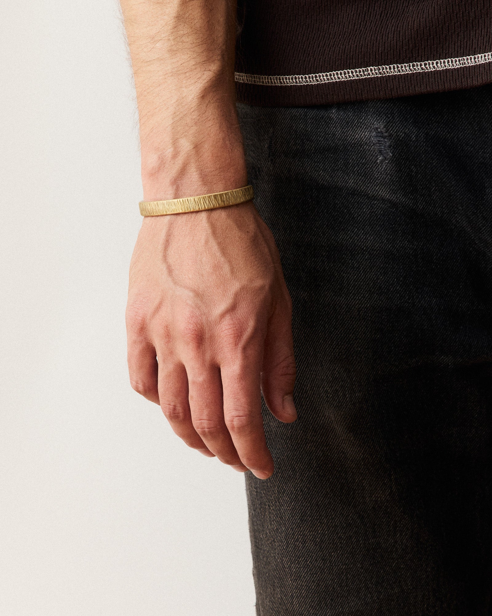 fit model posing in The Rough Cuff in Brass, Accessories by Taylor Stitch