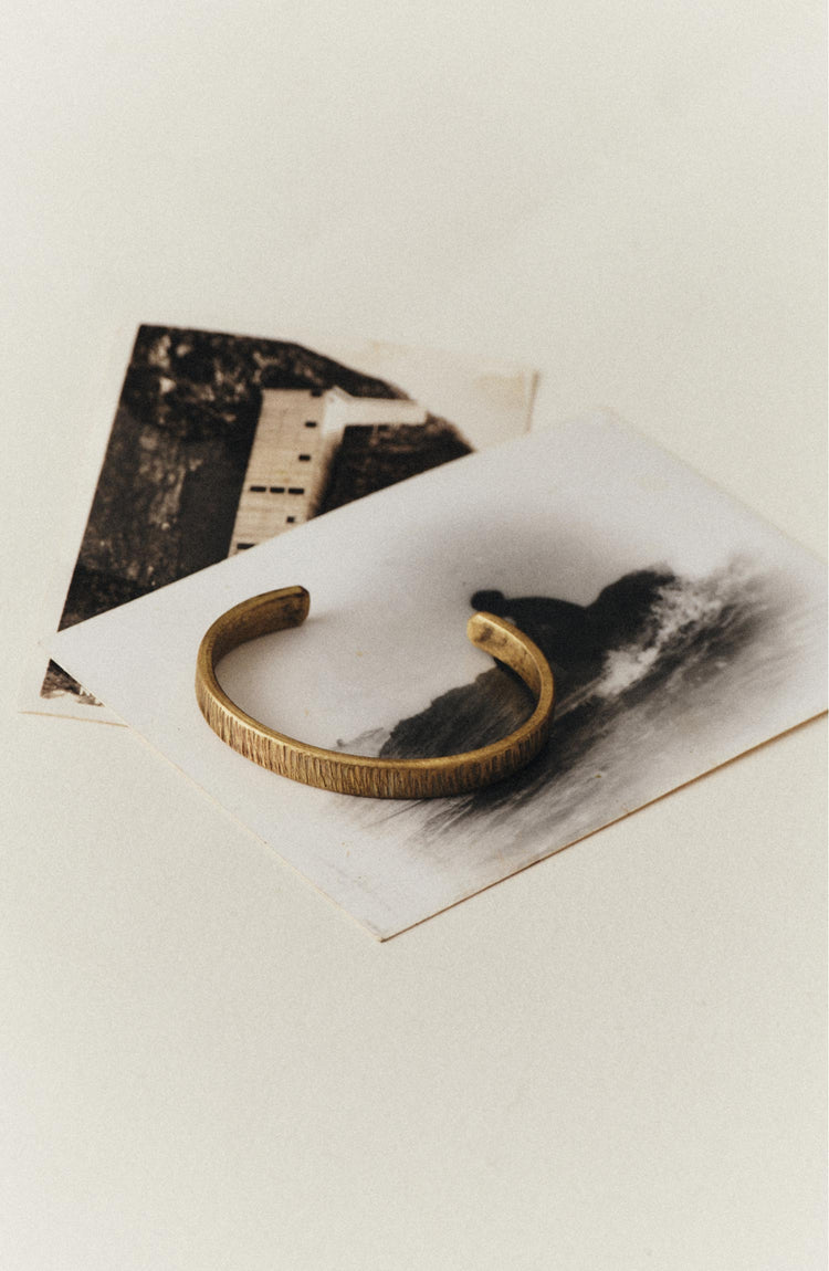 editorial image of The Rough Cuff in Brass on a postcard