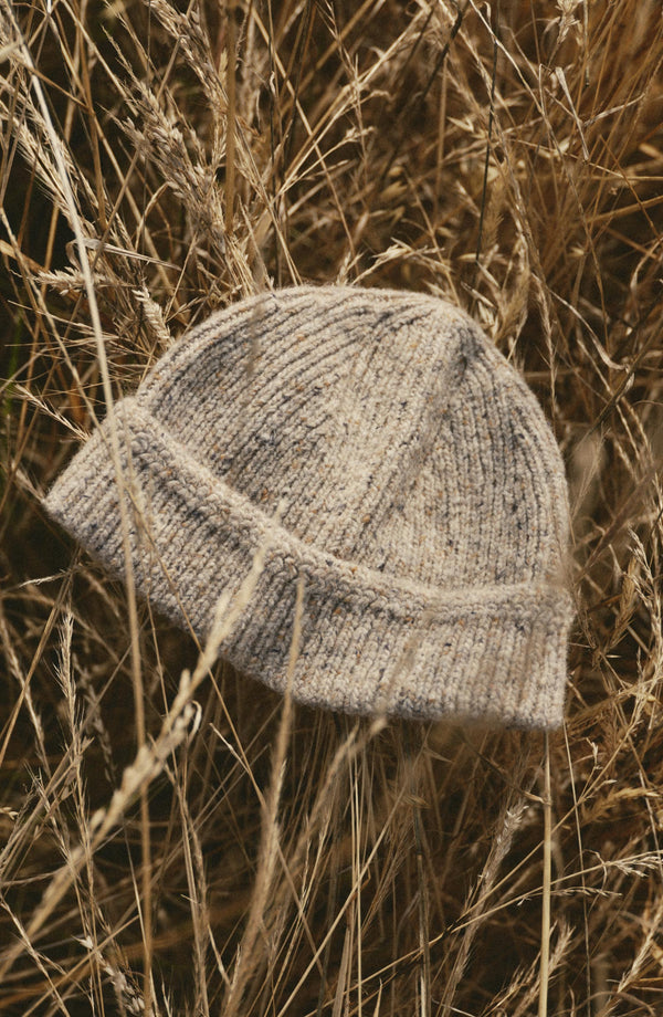 editorial image of The Seafarer Beanie in Natural Donegal in grass