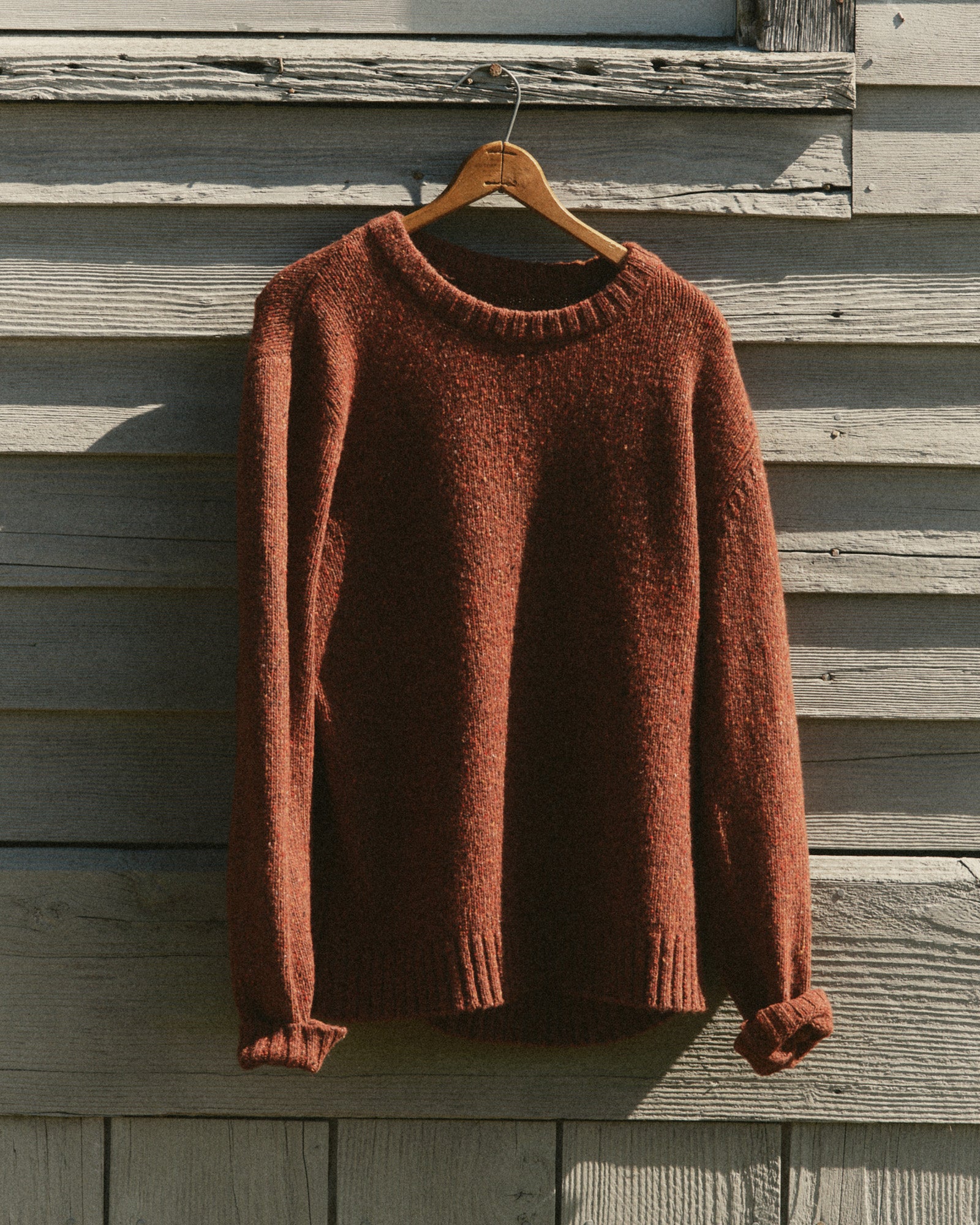 editorial image of The Seafarer Crew Sweater in Ember Donegal hanging, Sweaters by Taylor Stitch