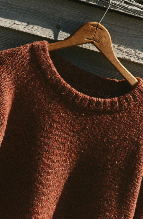 editorial image of The Seafarer Crew Sweater in Ember Donegal hanging