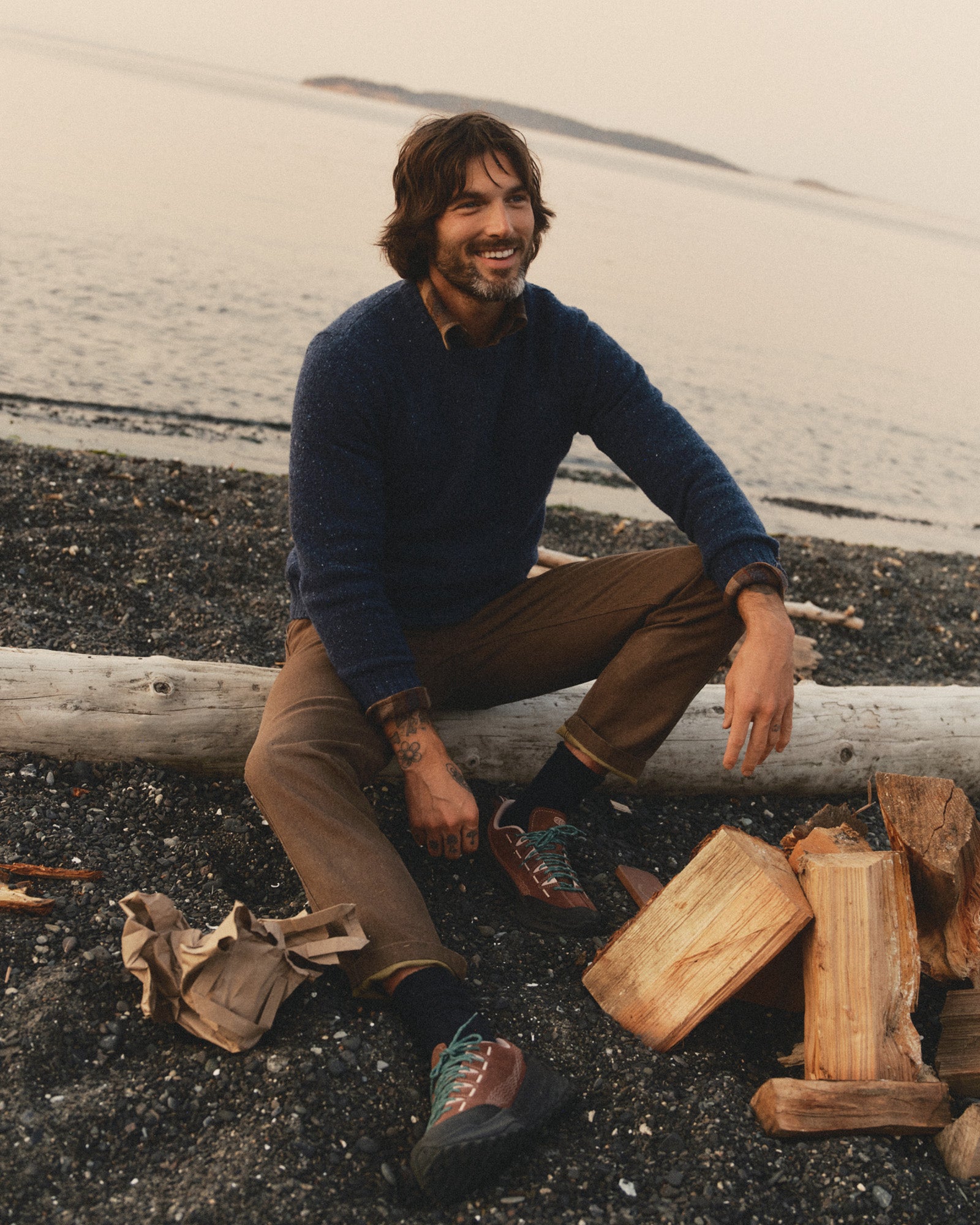 fit model sitting on a tree wearing The Seafarer Crew Sweater in Atlantic Blue Donegal, Sweaters by Taylor Stitch