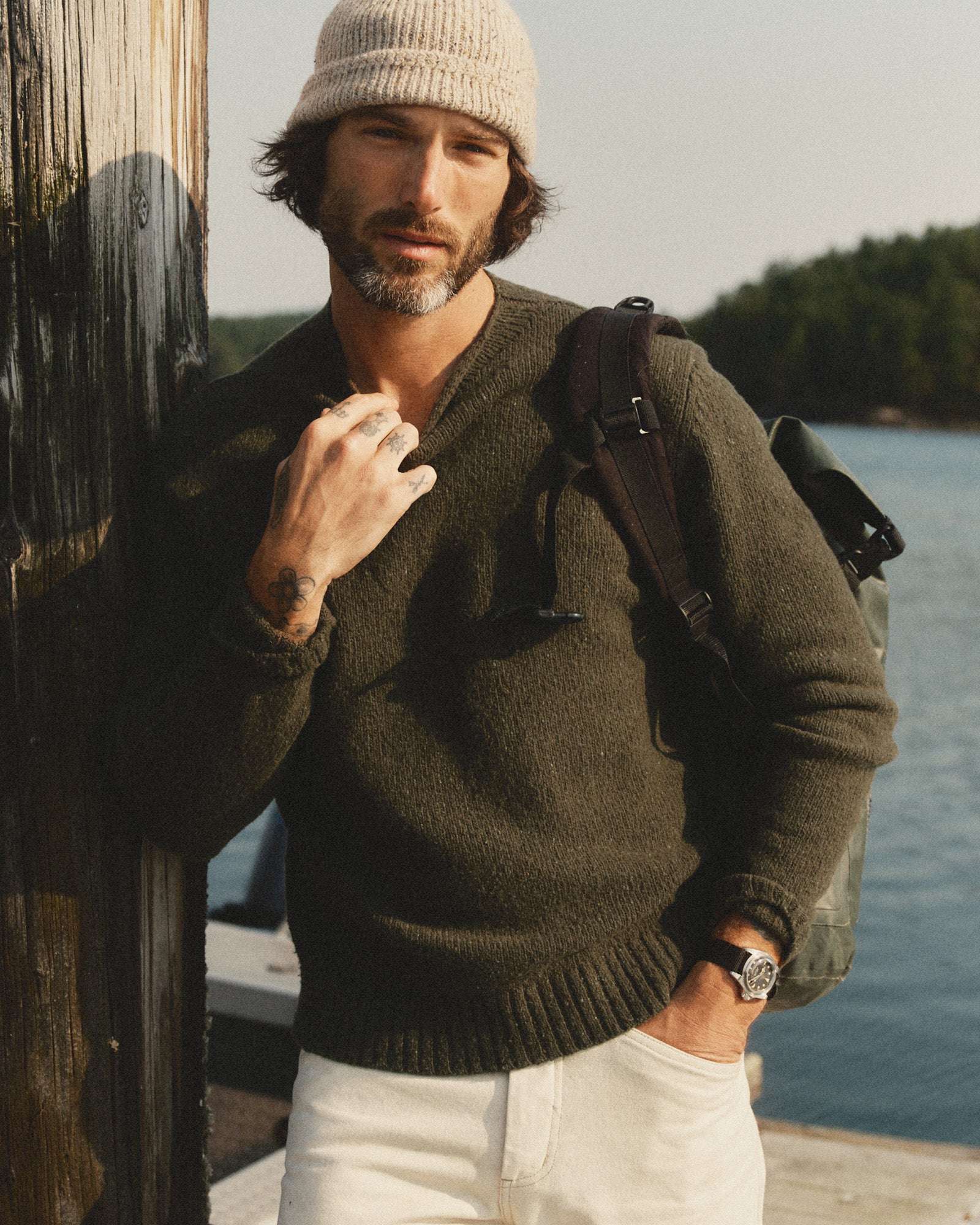 fit model leaning against a pole wearing The Seafarer Rollneck Sweater in Olive Donegal, Sweaters by Taylor Stitch
