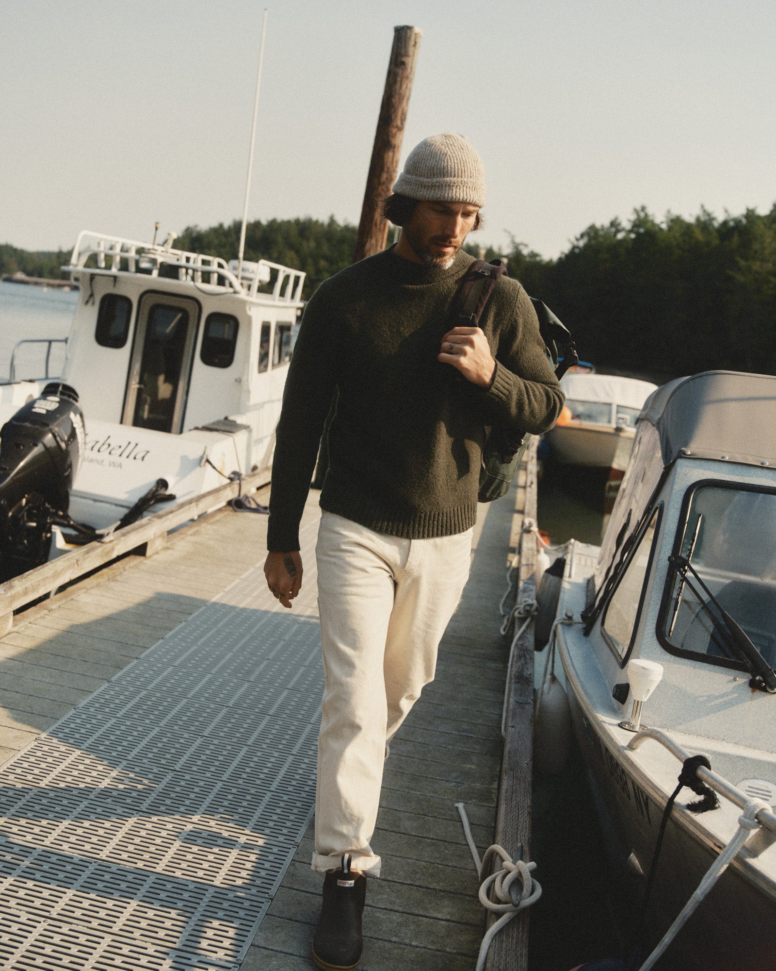 fit model walking wearing The Seafarer Rollneck Sweater in Olive Donegal, Sweaters by Taylor Stitch