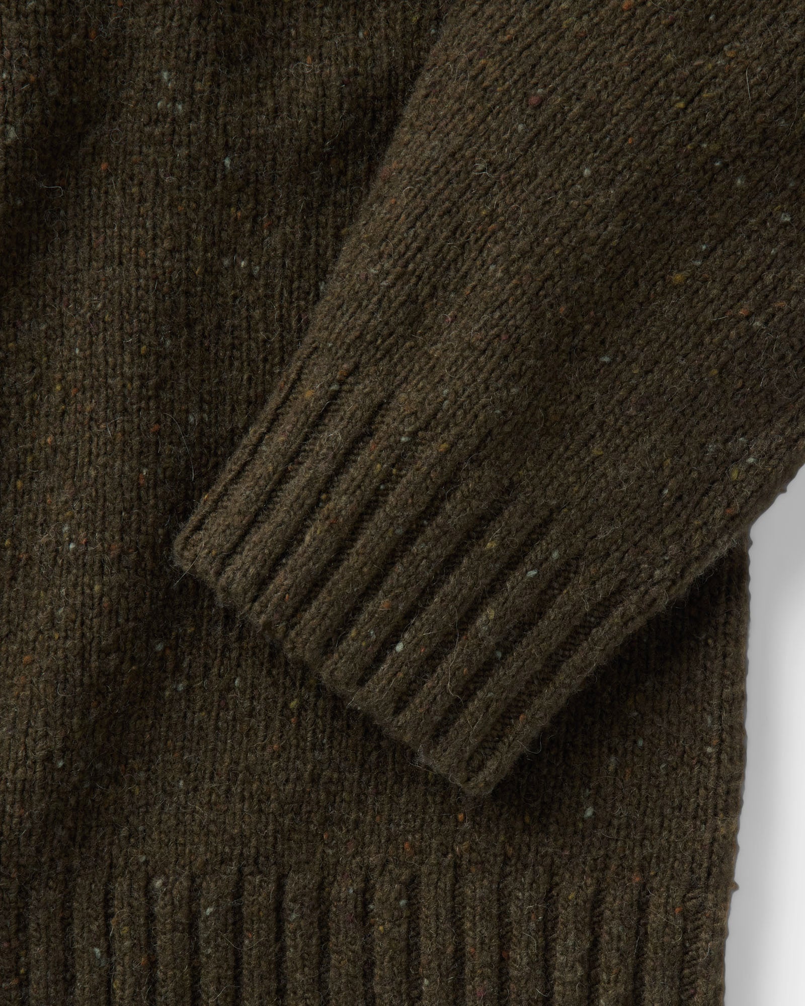 material shot of the sleeve on The Seafarer Rollneck Sweater in Olive Donegal, Sweaters by Taylor Stitch