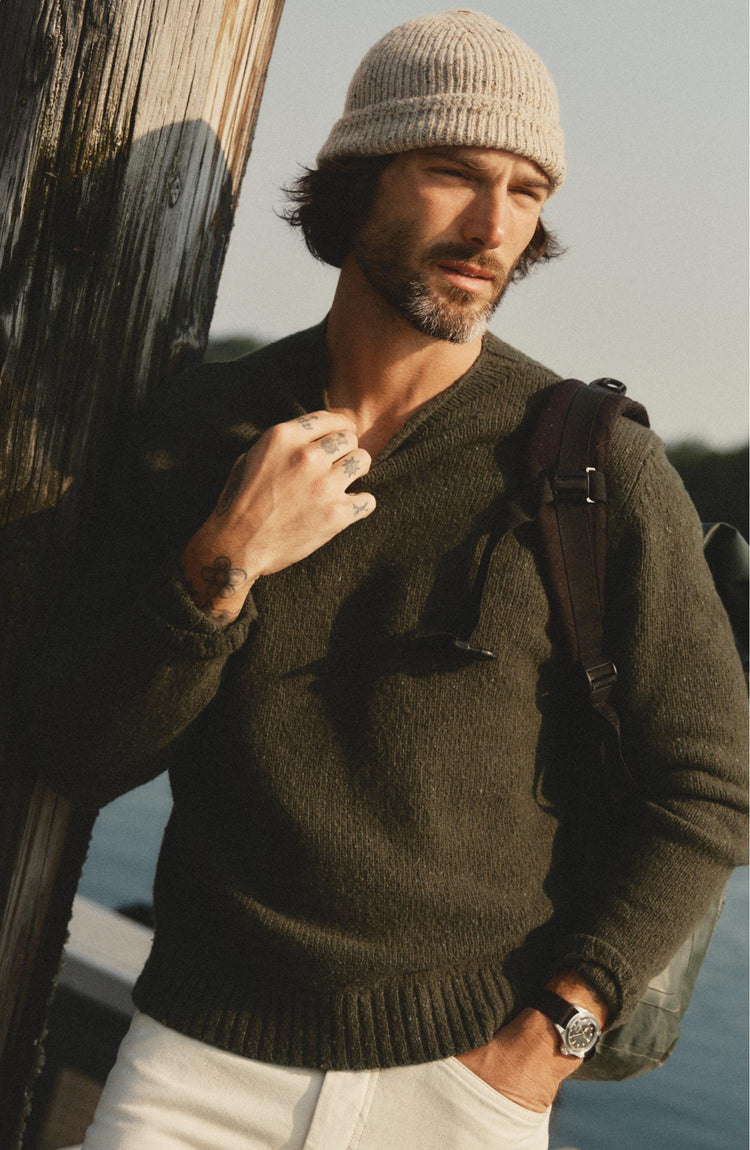 fit model posing in The Seafarer Rollneck Sweater in Olive Donegal