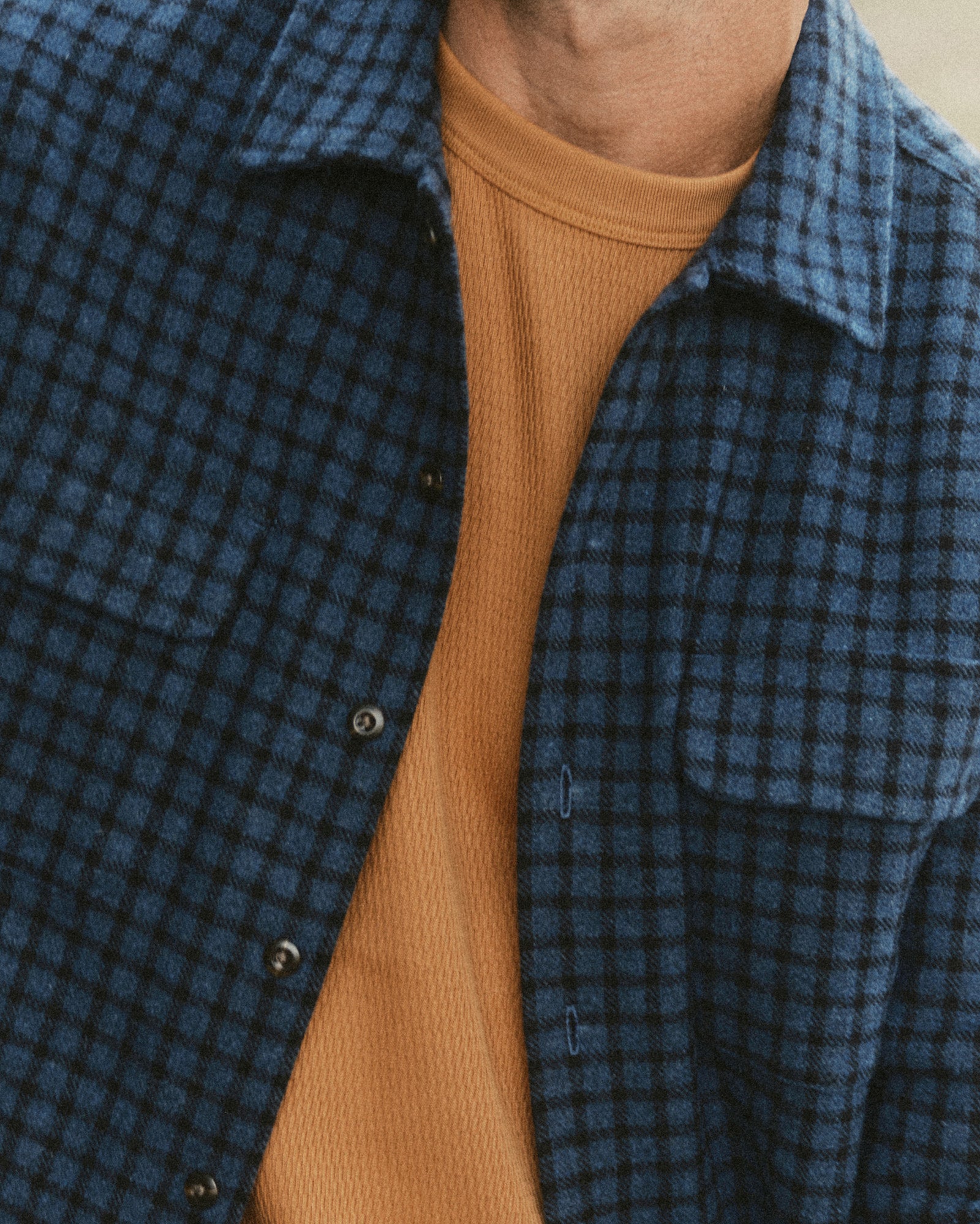 fit model showing off the buttons on The Shore Shirt in Midnight Check Wool, Wovens by Taylor Stitch