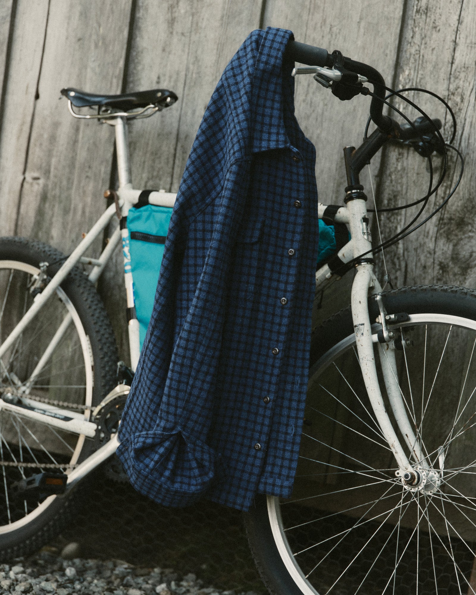 editorial image of The Shore Shirt in Midnight Check Wool on a bike, Wovens by Taylor Stitch