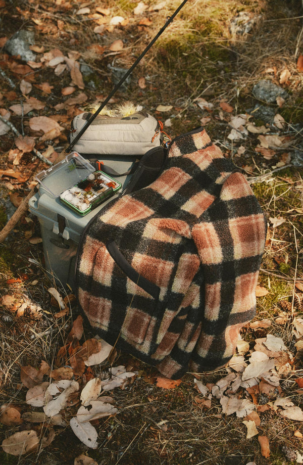 editorial flatlay of The Alta Jacket in Montana Plaid Fleece