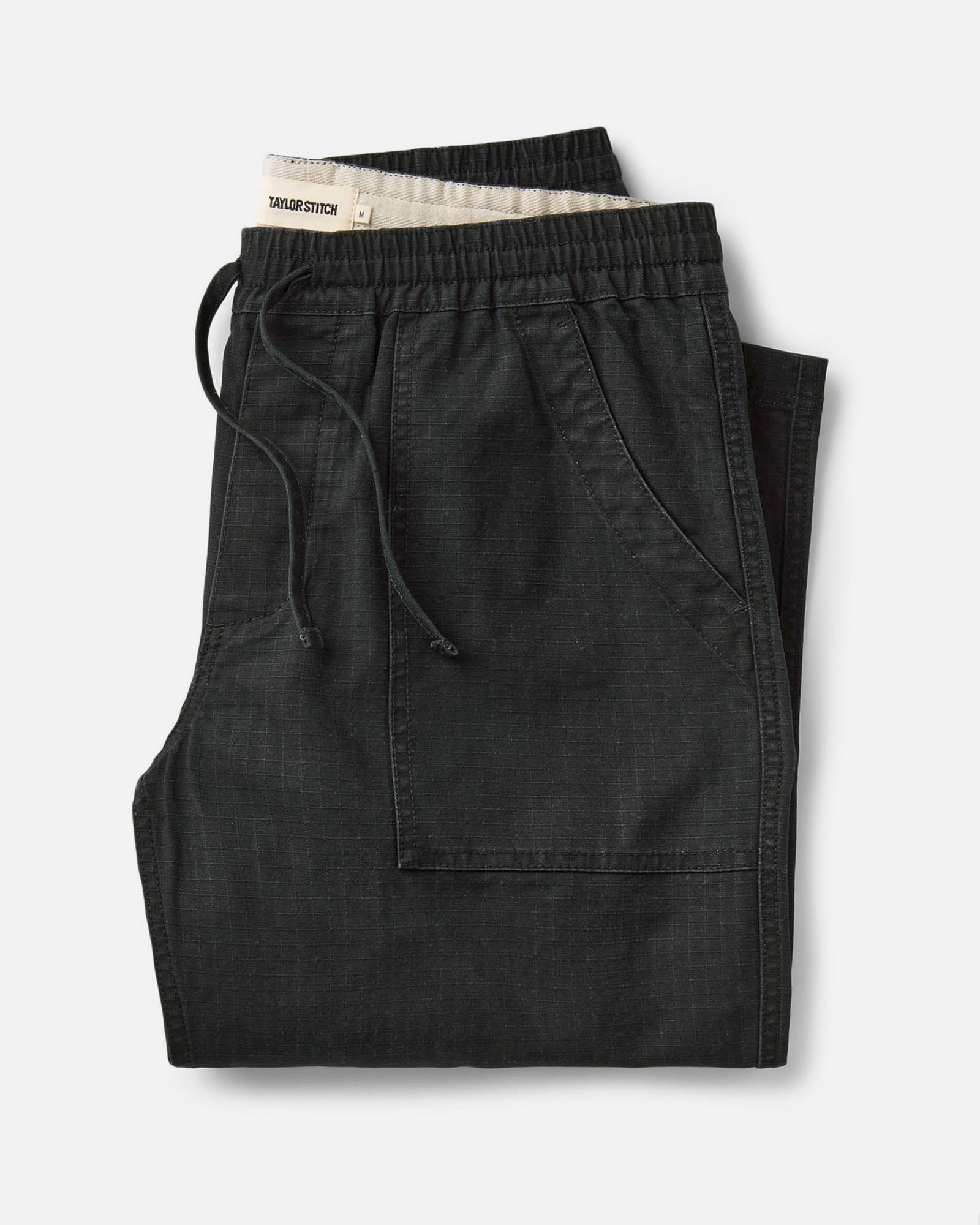 a folded flatlay of The Breakwater Pants, Bottoms by Taylor Stitch