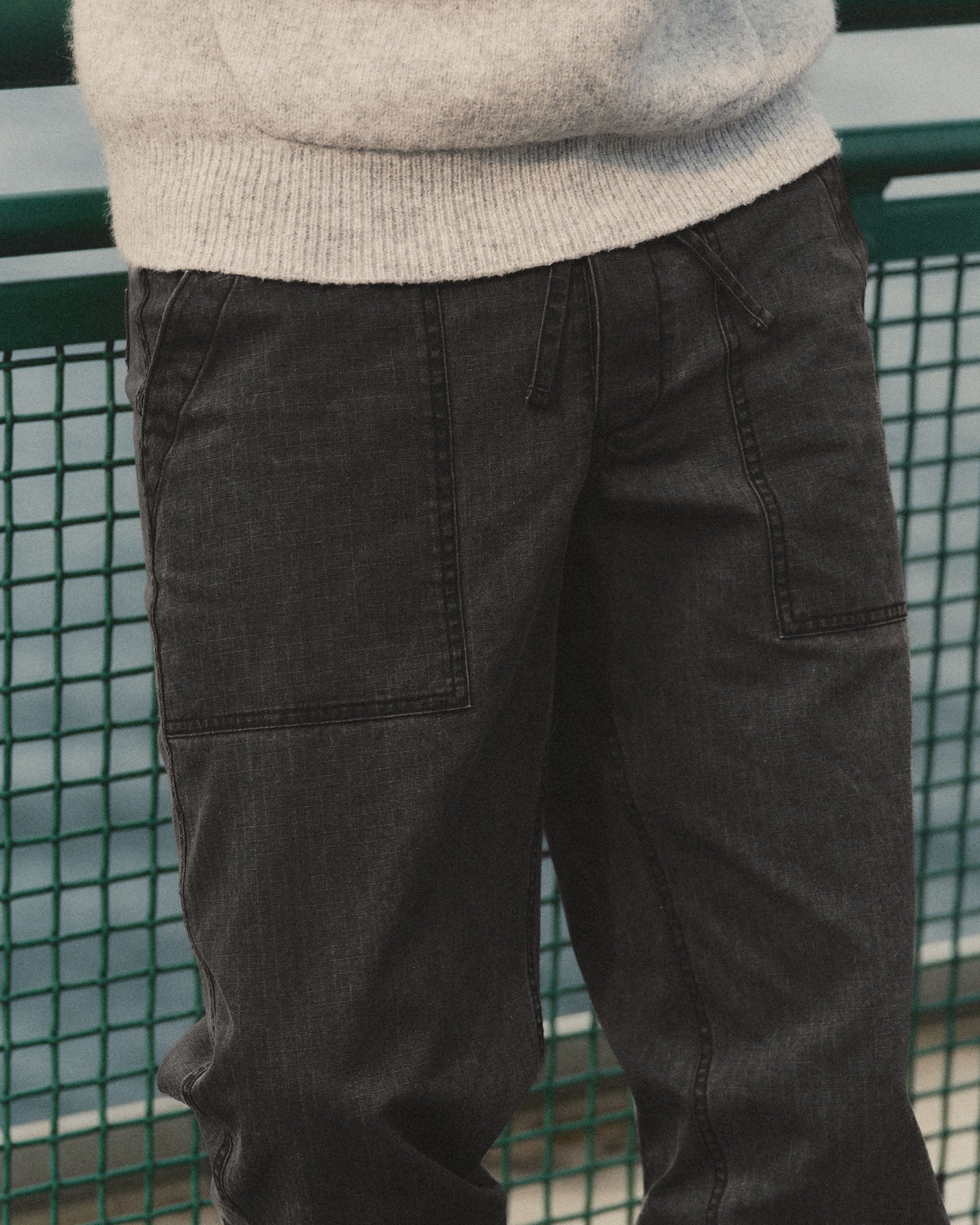 fit model showing off the pockets on The Breakwater Pant in Coal Ripstop, Bottoms by Taylor Stitch