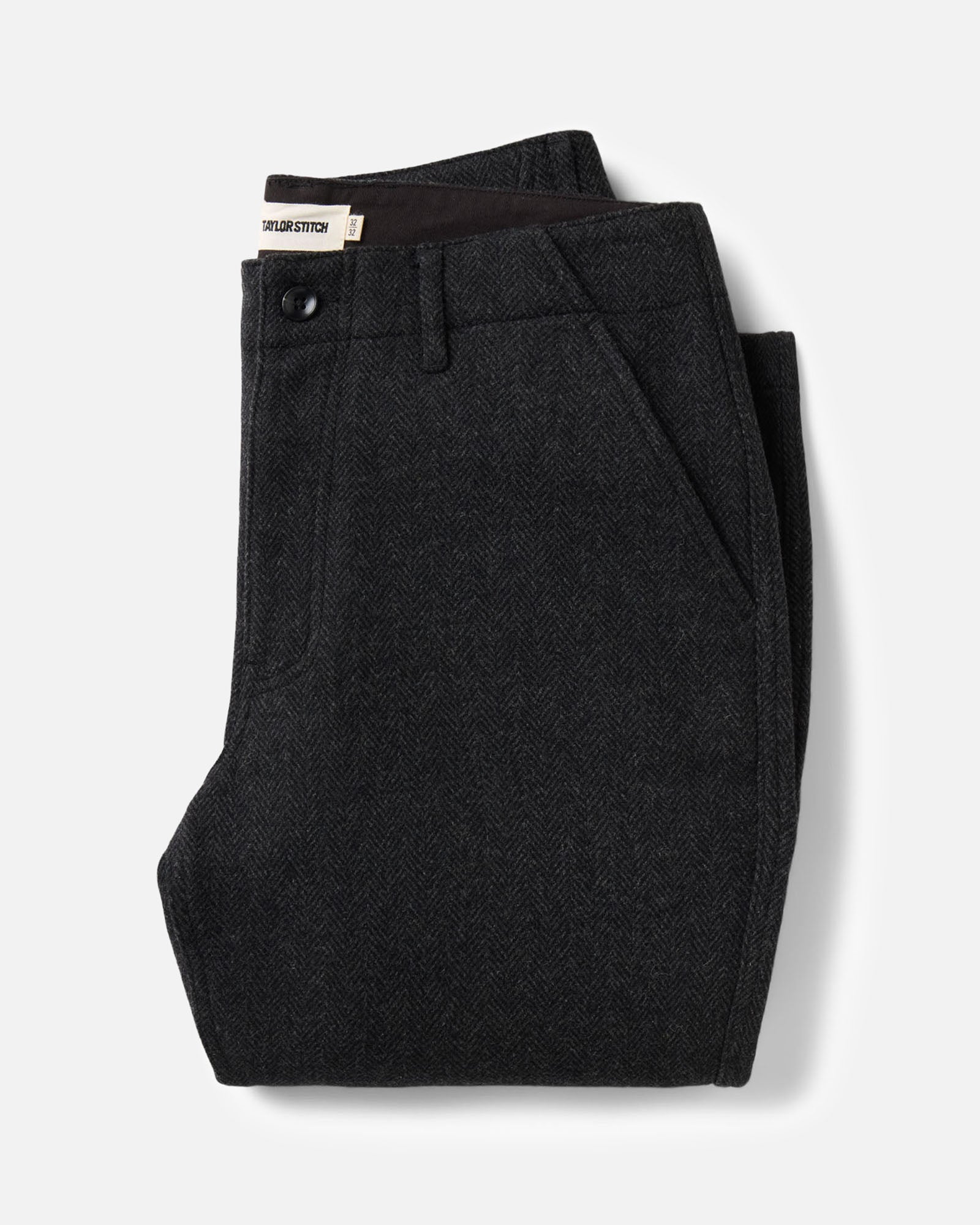folded flatlay of The Carnegie Pant in Coal Herringbone Wool, Bottoms by Taylor Stitch