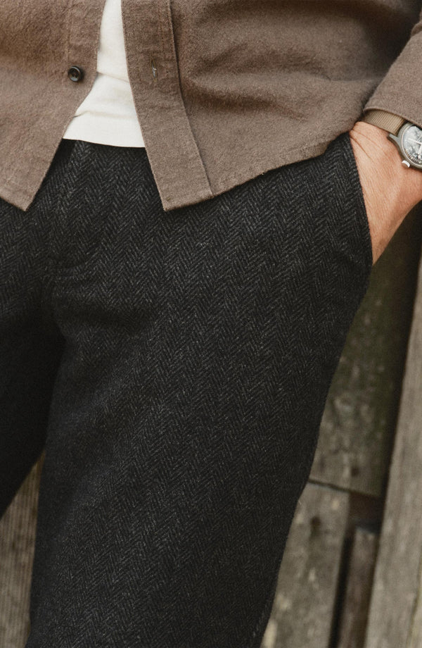 fit model with his hand in the pocket of The Carnegie Pant in Coal Herringbone Wool