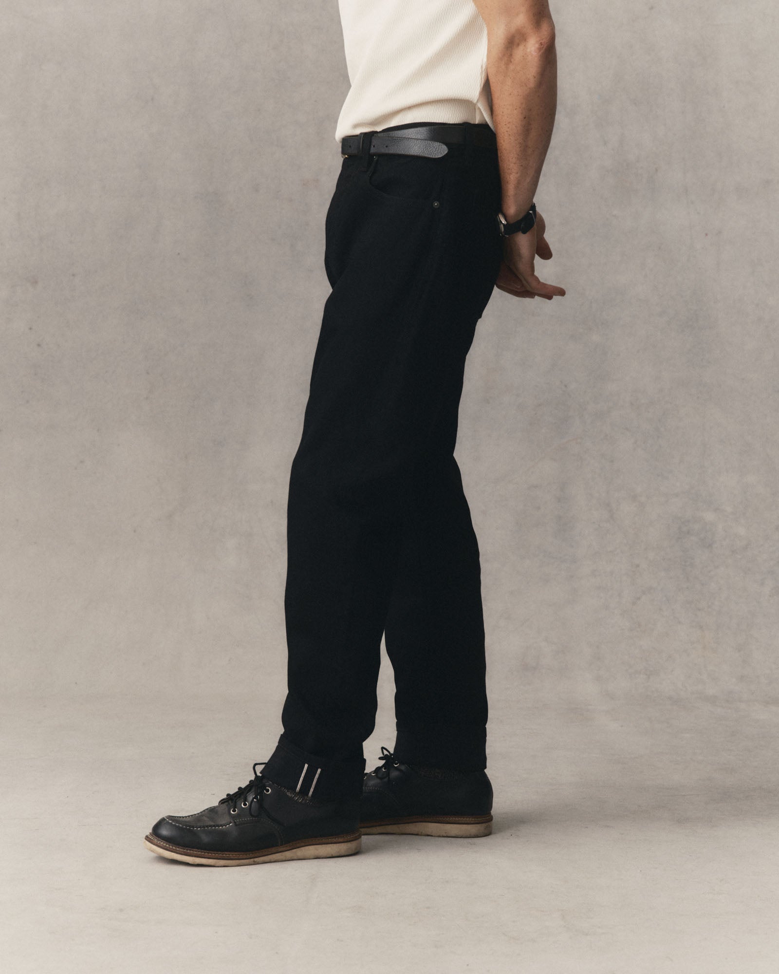 fit model showing off The Democratic Jean in Rinsed Black Organic Selvedge, Bottoms by Taylor Stitch