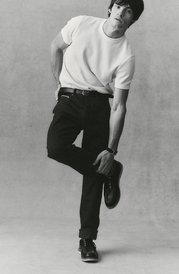 fit model showing off The Democratic Jean in Rinsed Black Organic Selvedge