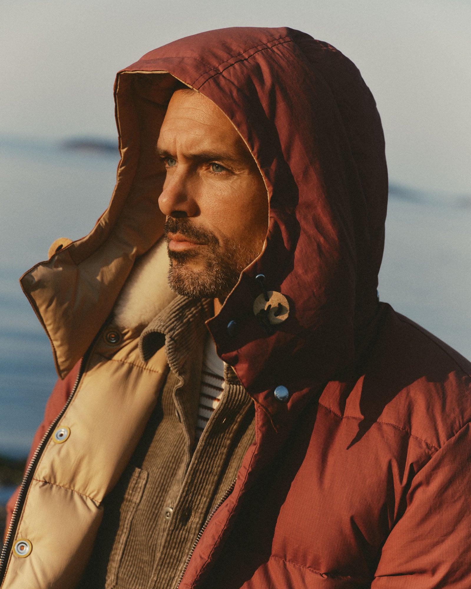 fit model showing off the hood on The Down Sweater Jacket in Brick Red Waxed Ripstop, Outerwear by Taylor Stitch