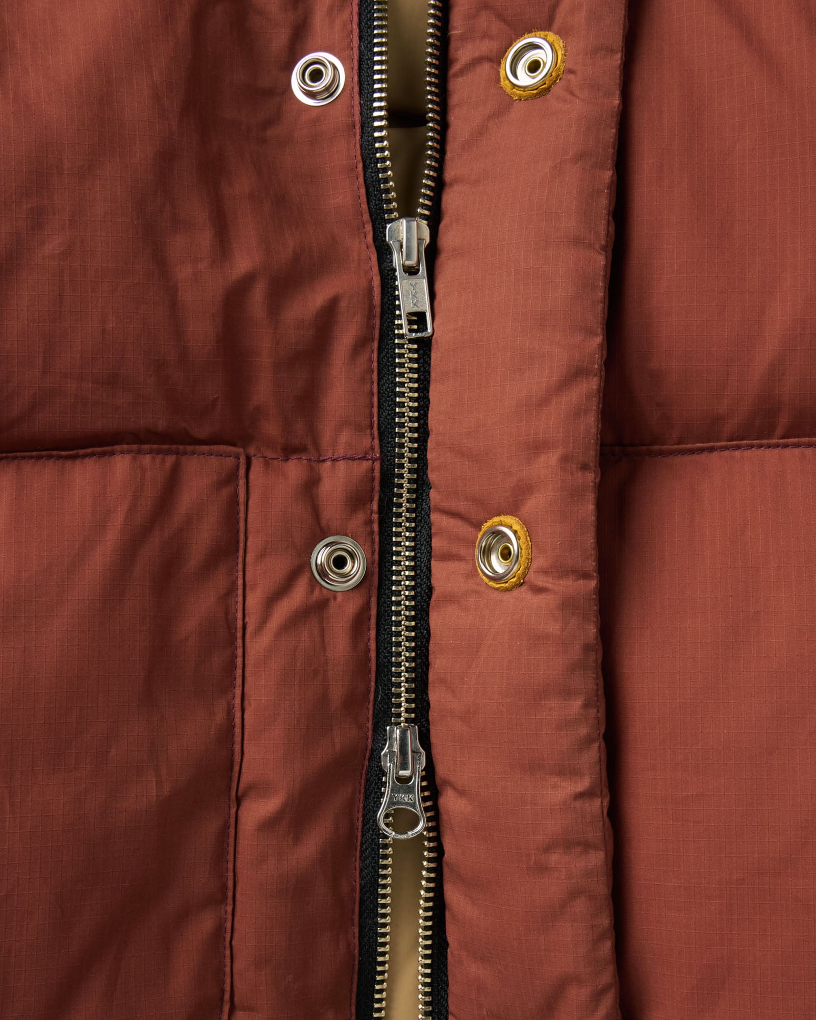 material shot of the zipper on The Down Sweater Jacket in Brick Red Waxed Ripstop, Outerwear by Taylor Stitch