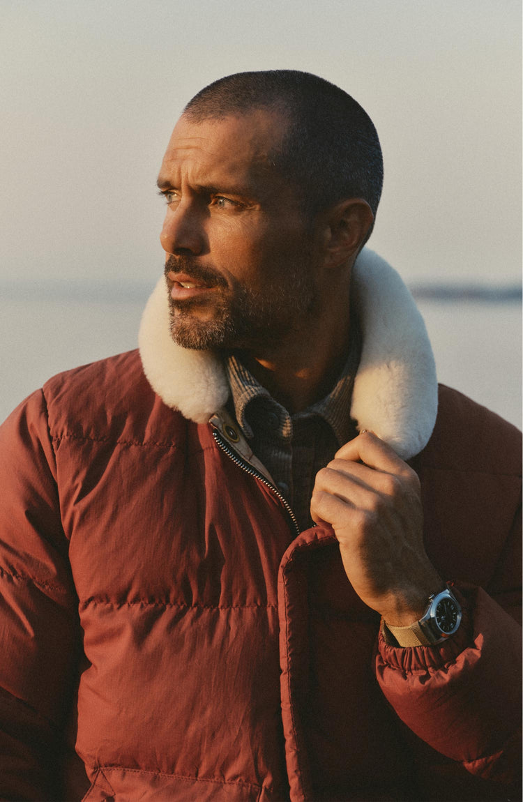fit model posing in The Down Sweater Jacket in Brick Red Waxed Ripstop