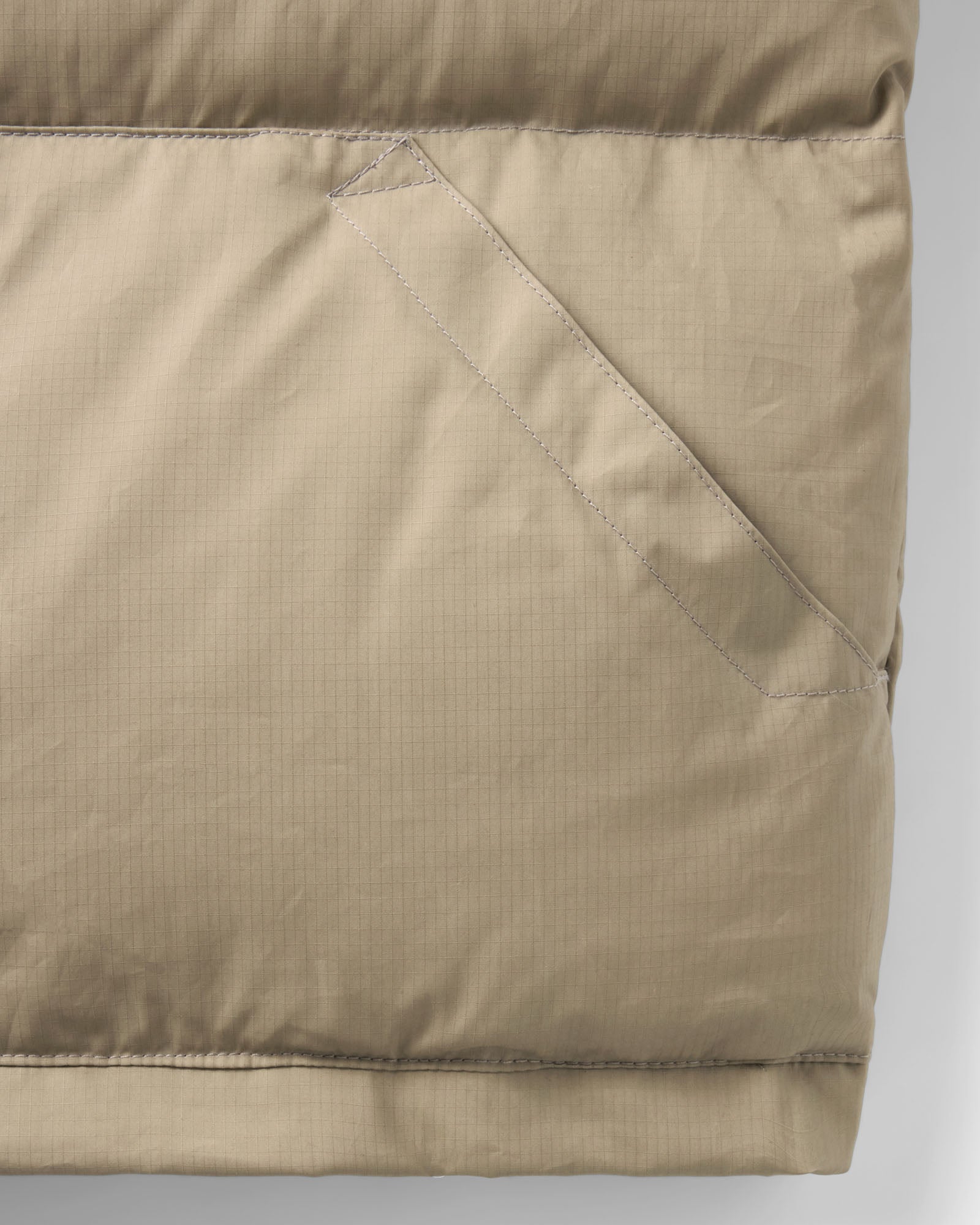 material shot of the pocket on The Down Vest in Khaki Waxed Ripstop, Outerwear by Taylor Stitch