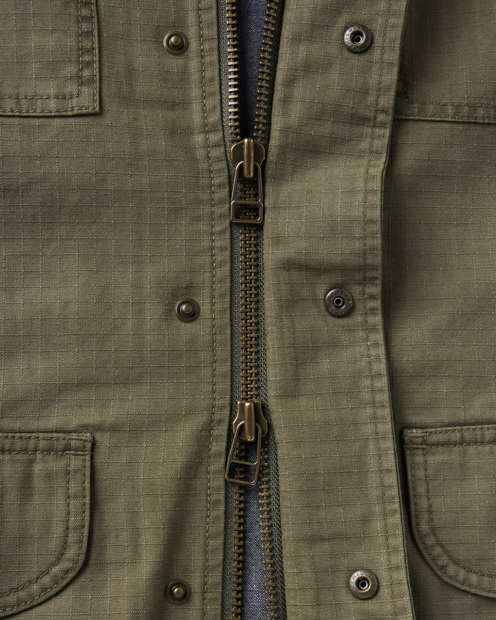 material shot of the zipper on The Field Jacket in Burnt Olive Ripstop, Outerwear by Taylor Stitch