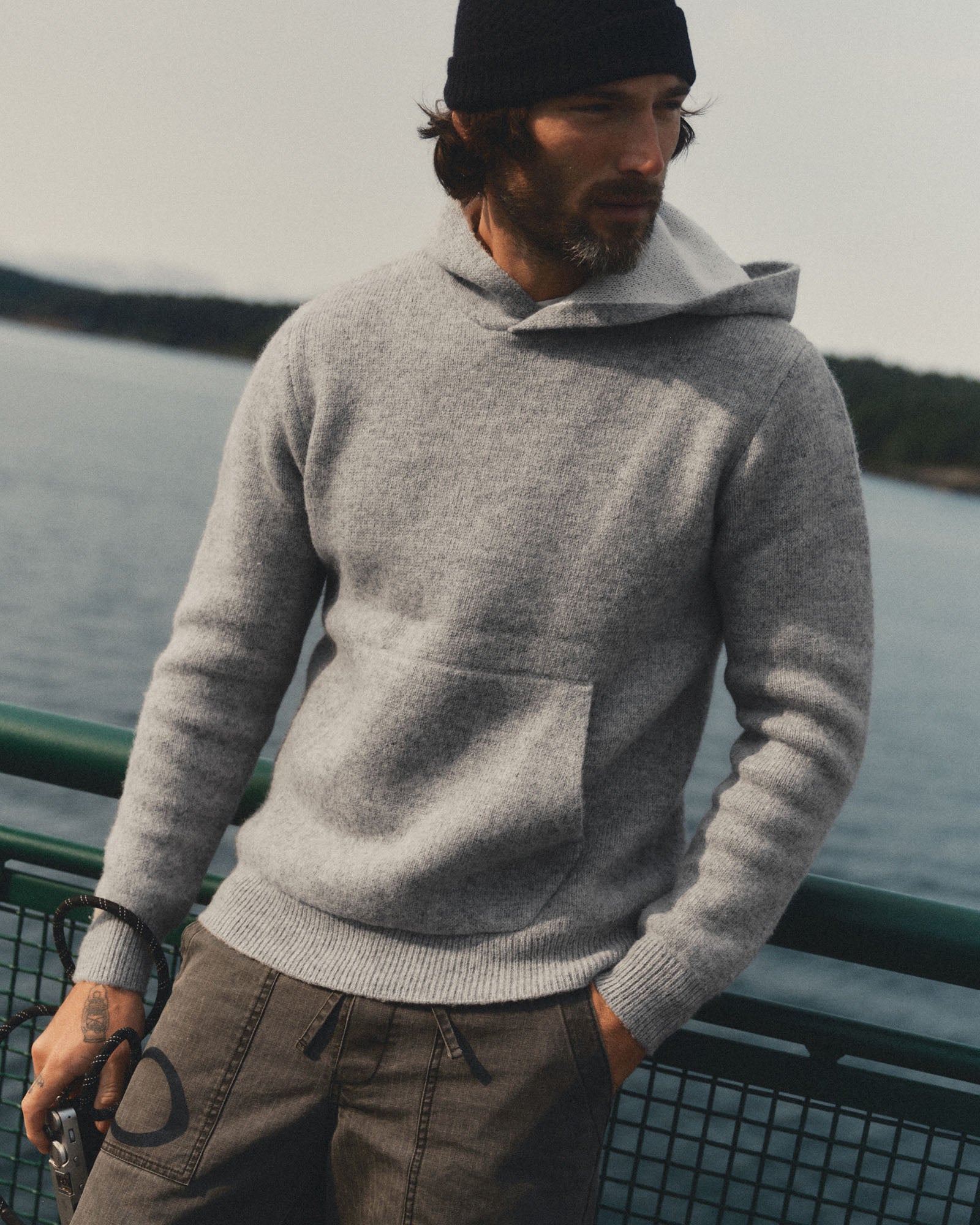 fit model posing in The Haven Sweater Hoodie in Heather Grey Wool, Sweaters by Taylor Stitch