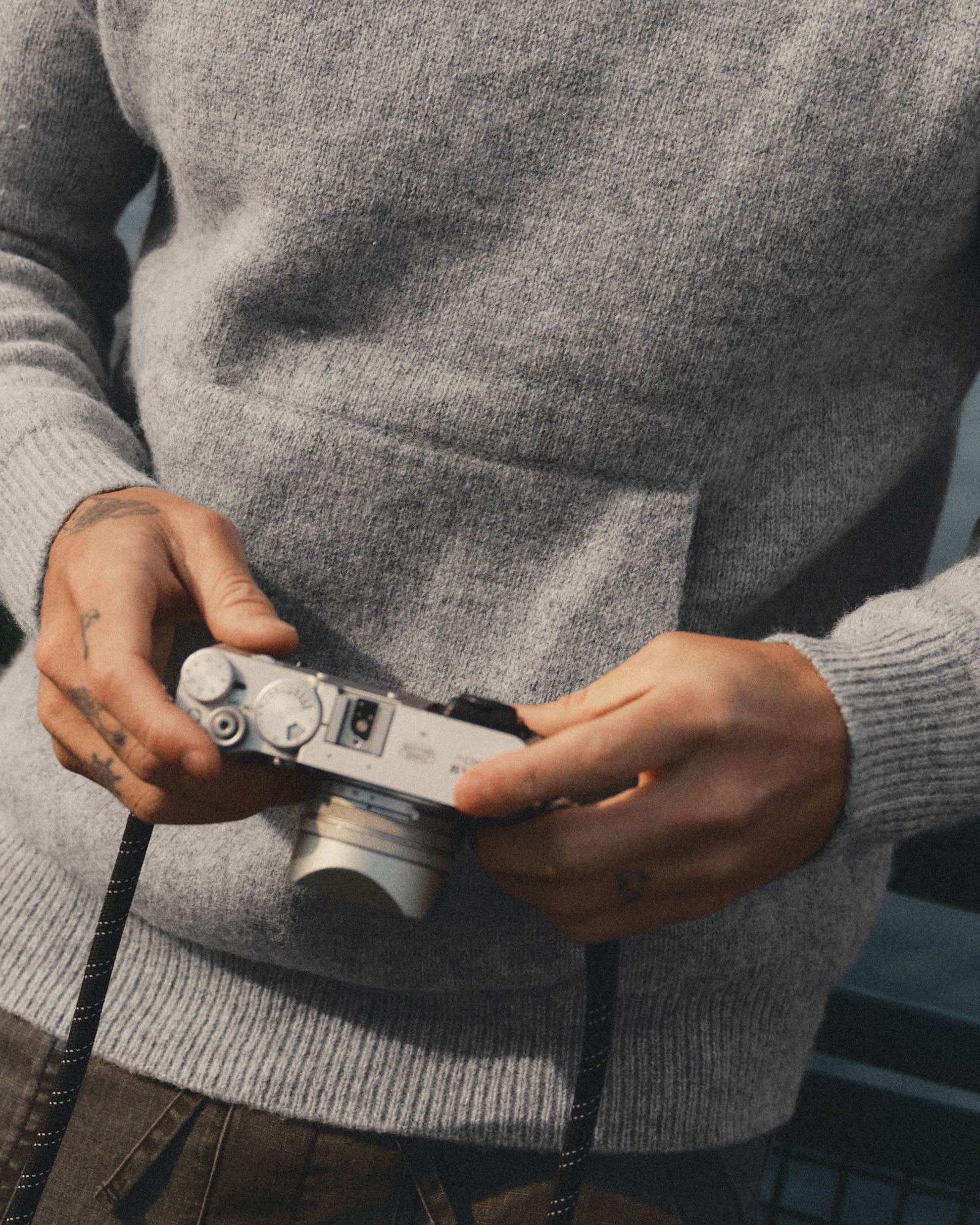 fit model showing off the pocket on The Haven Sweater Hoodie in Heather Grey Wool, Sweaters by Taylor Stitch