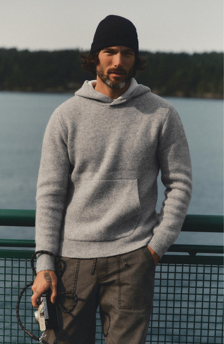 fit model posing in The Haven Sweater Hoodie in Heather Grey Wool