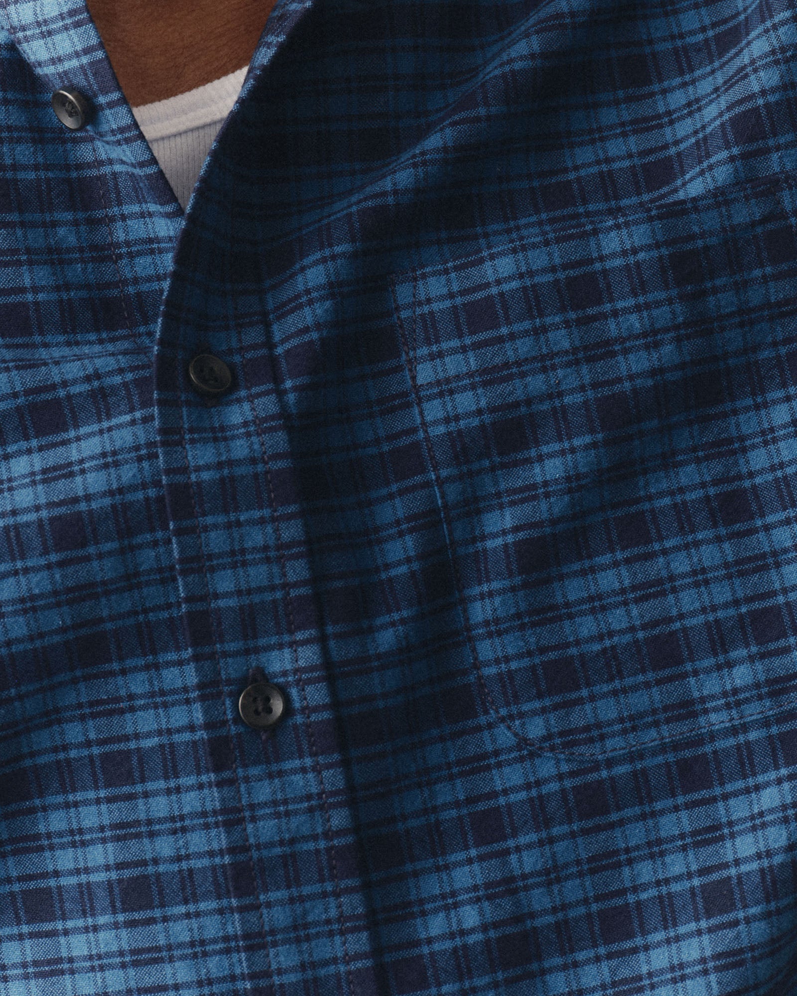 fit model showing off the buttons on The Jack in Crescent Plaid Oxford, Wovens by Taylor Stitch