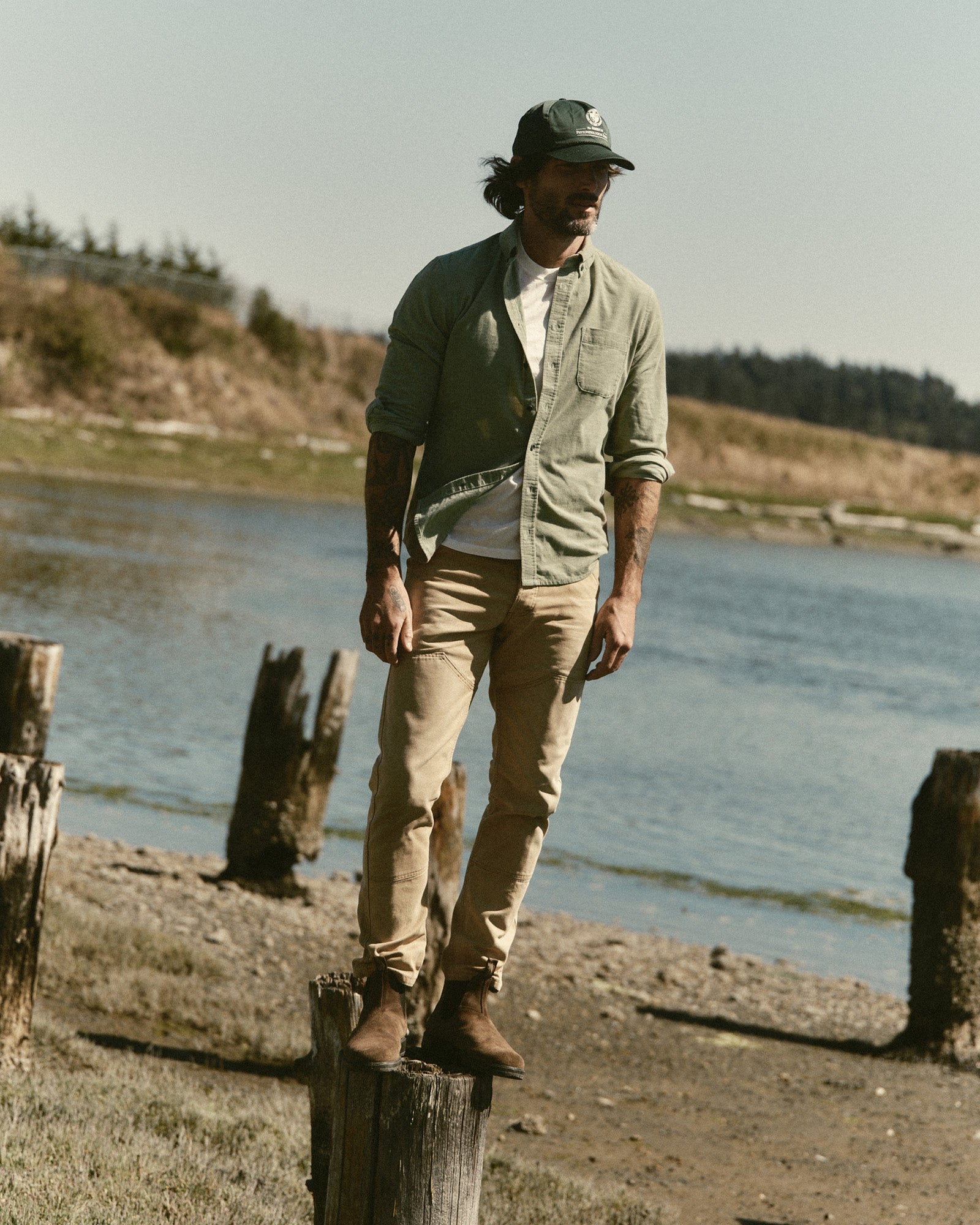 fit model standing on a column wearing The Jack in Heather Moss Pincord, Wovens by Taylor Stitch
