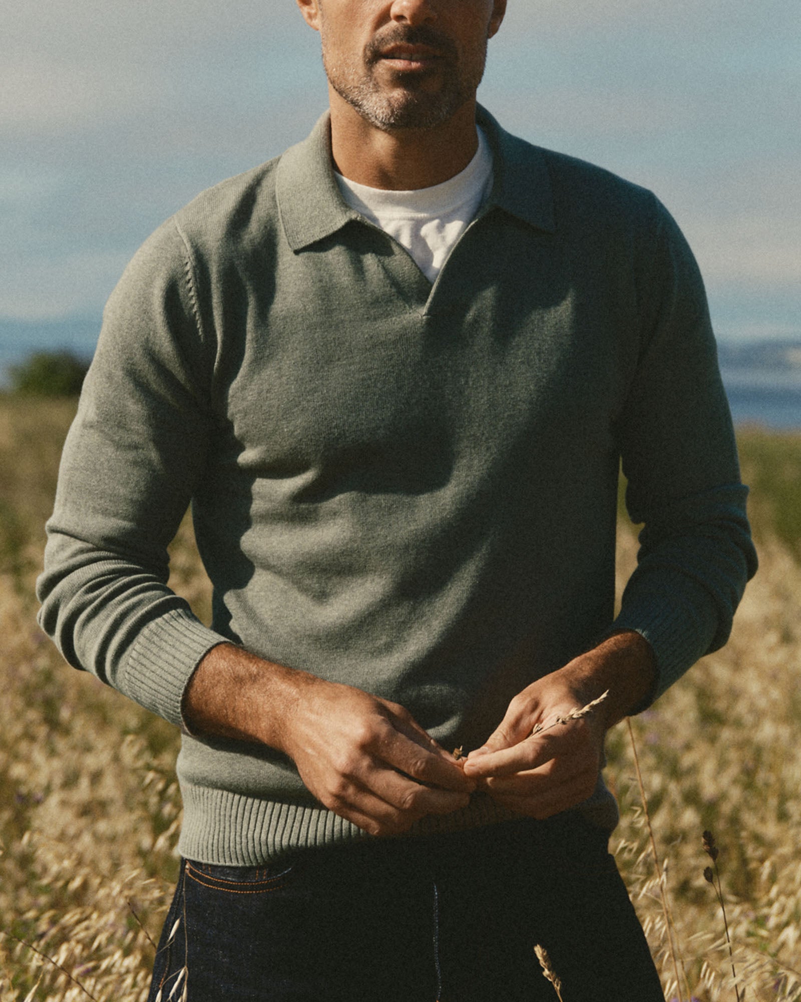 fit model posing in The Long Sleeve Valencia Sweater Polo in Olive, Sweaters by Taylor Stitch