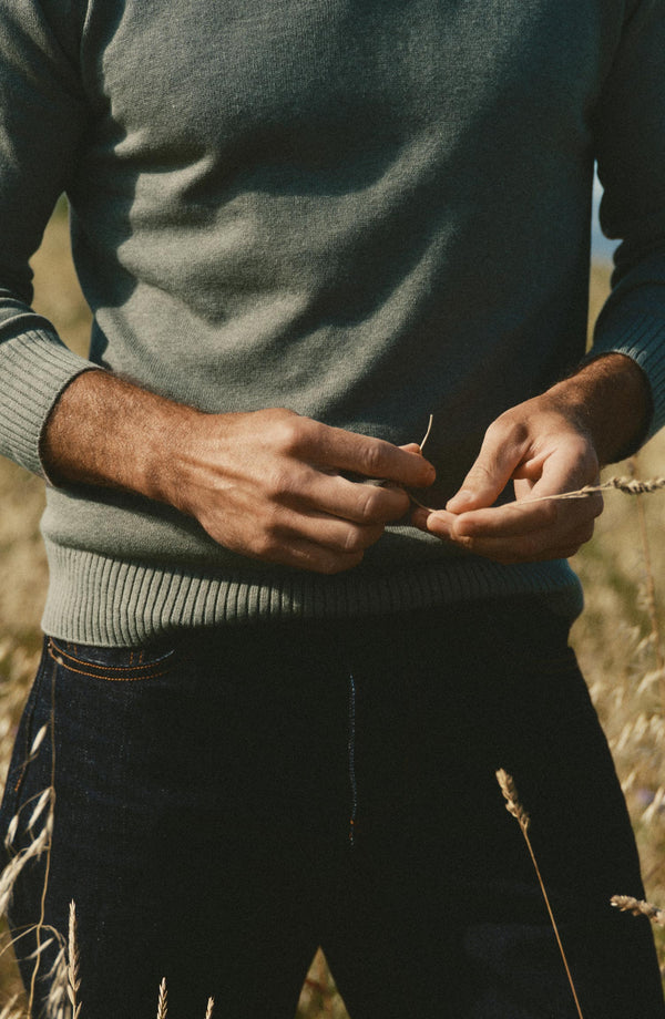 fit model showing off the bottom of The Long Sleeve Valencia Sweater Polo in Olive