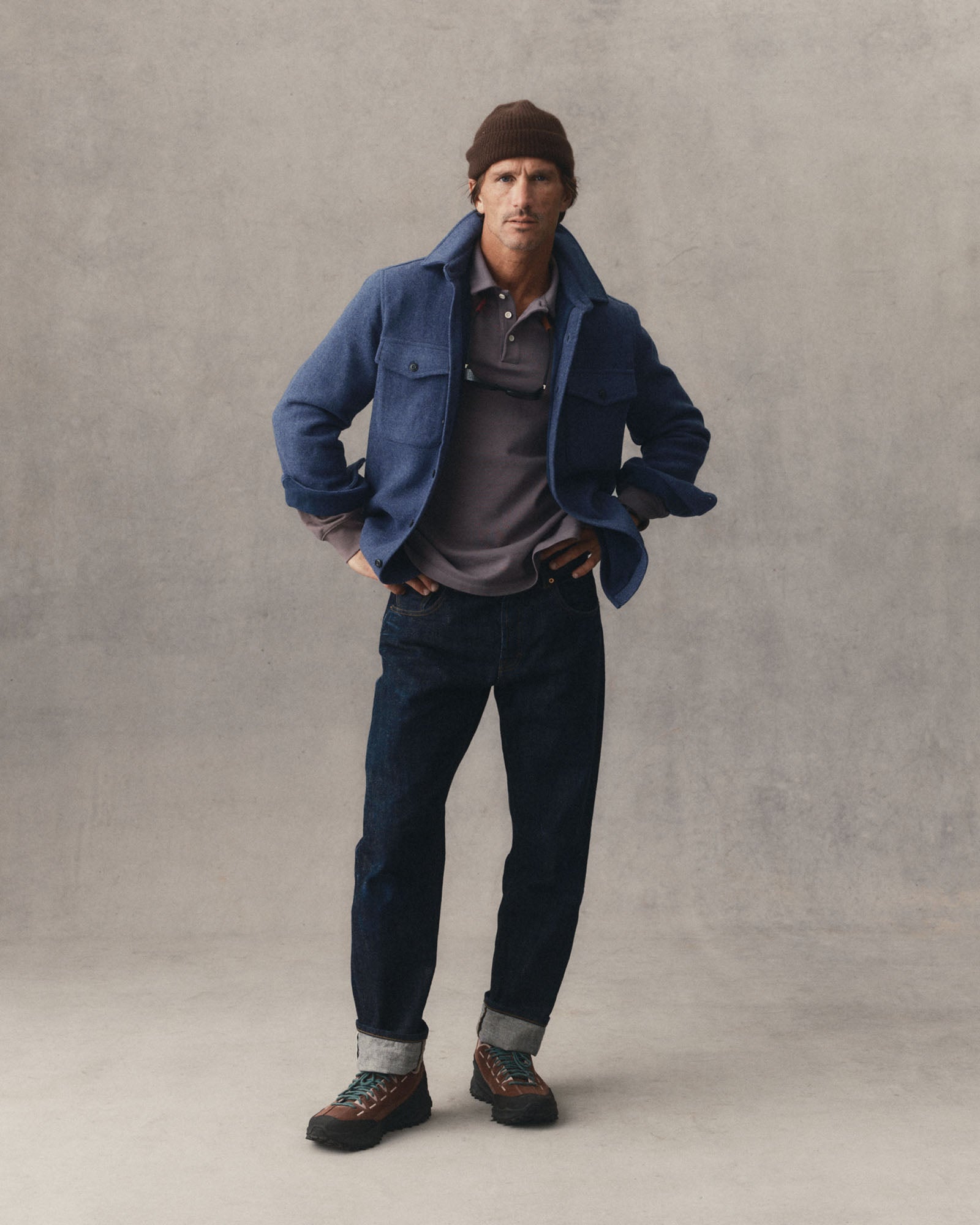 fit model with his hands on his arms wearing The Maritime Shirt Jacket in Heather Navy Wool, Outerwear by Taylor Stitch
